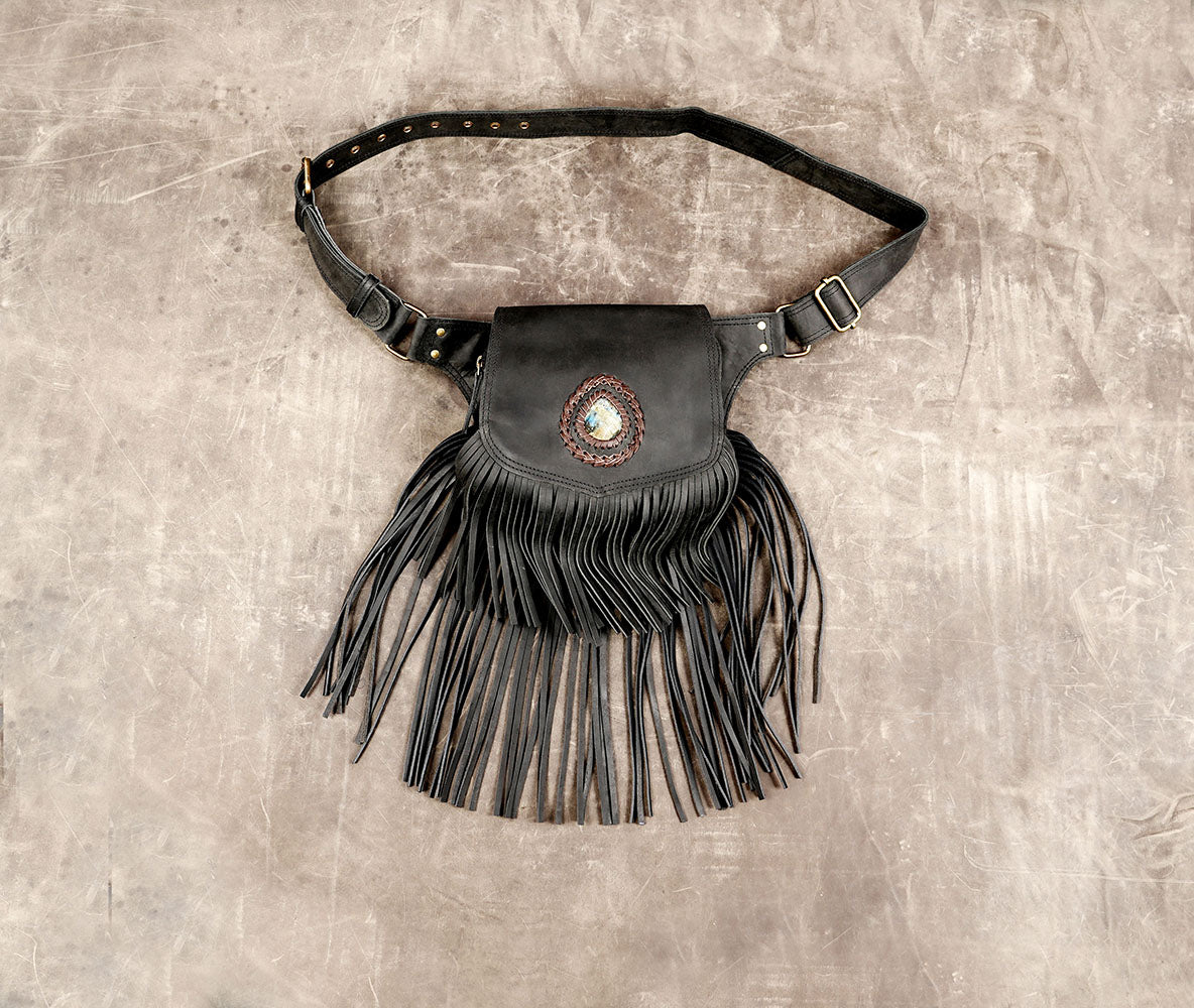 Black leather fanny pack with fringe and gemstone detail for boho festival outfits