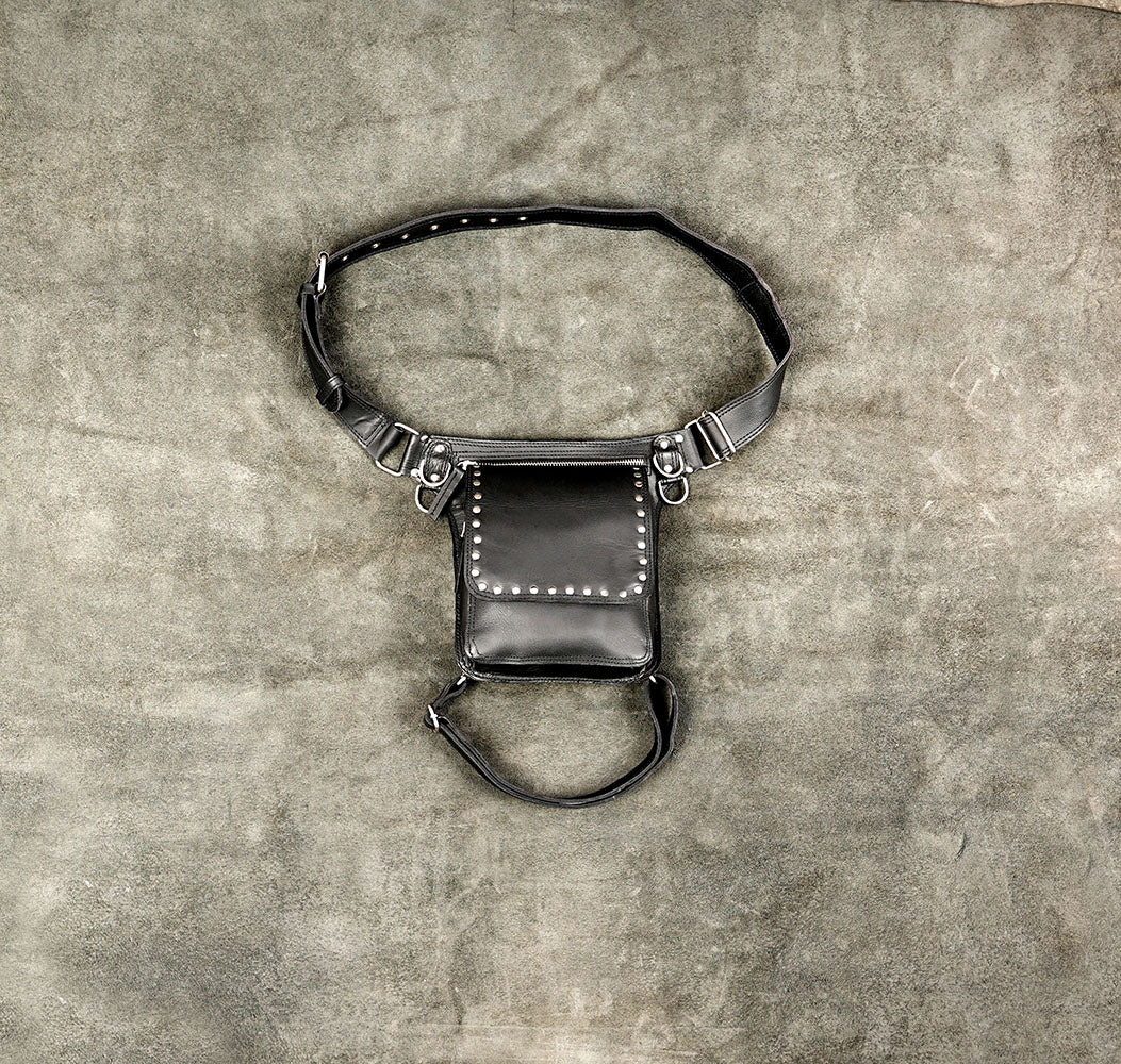 Black leather thigh bag with silver studs and adjustable waist strap.