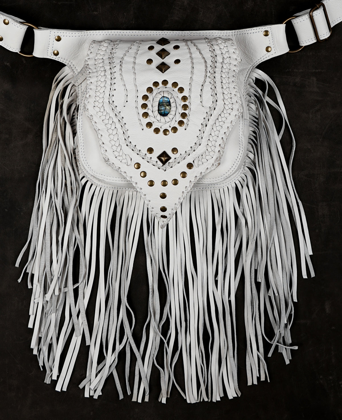 White leather utility belt bag with fringe and decorative hardware

