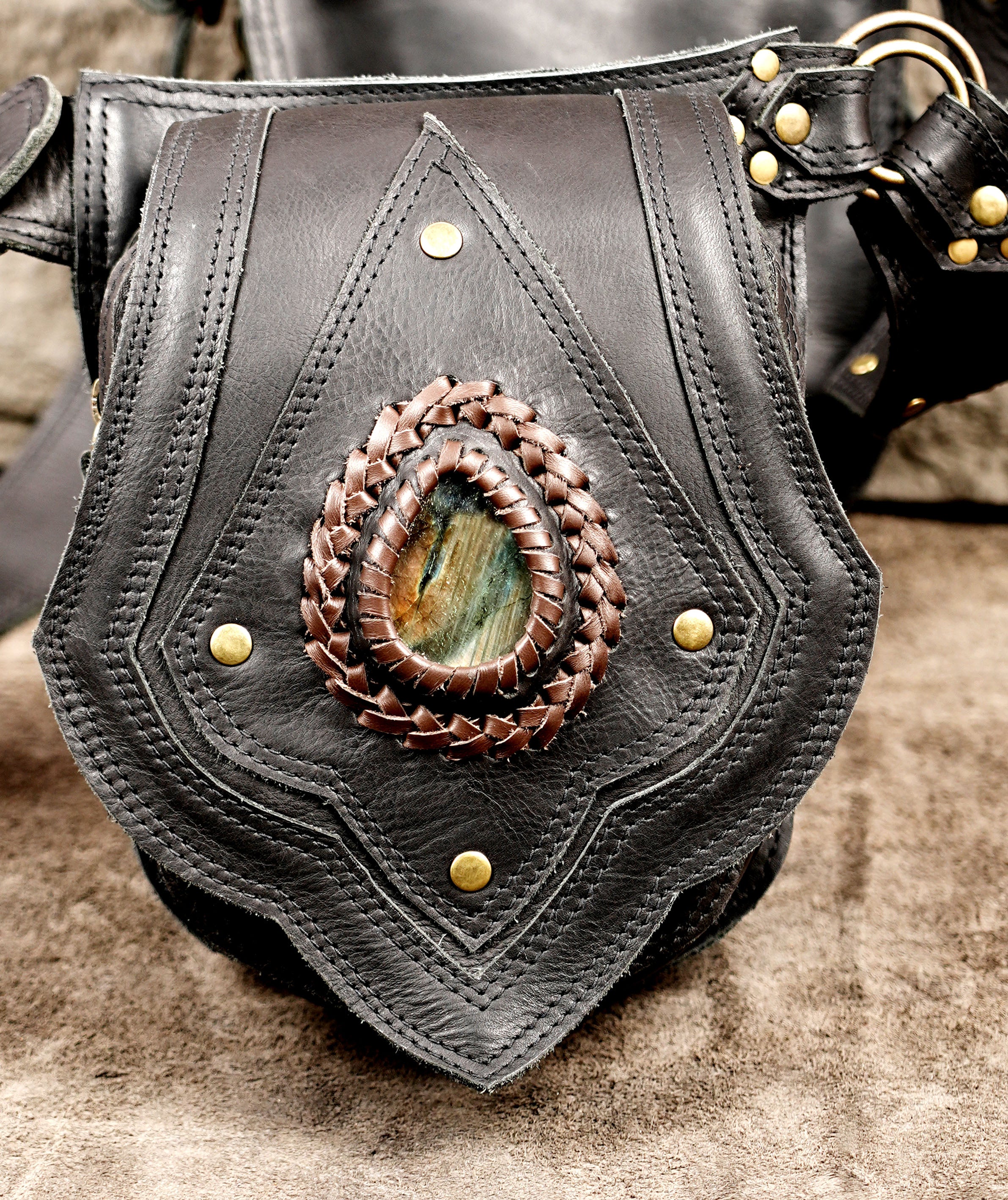 Adjustable black leather hip bag with brass hardware