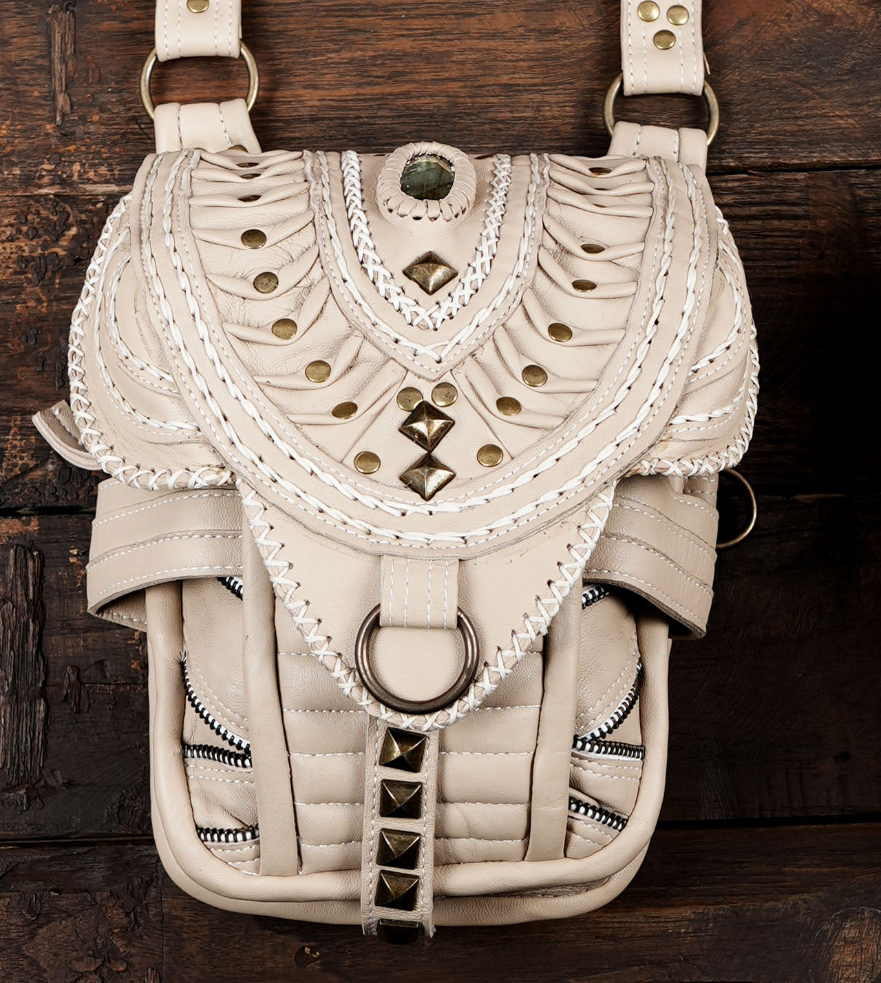 Bohemian style dual hip pouch harness in beige leather with gemstone embellishments.