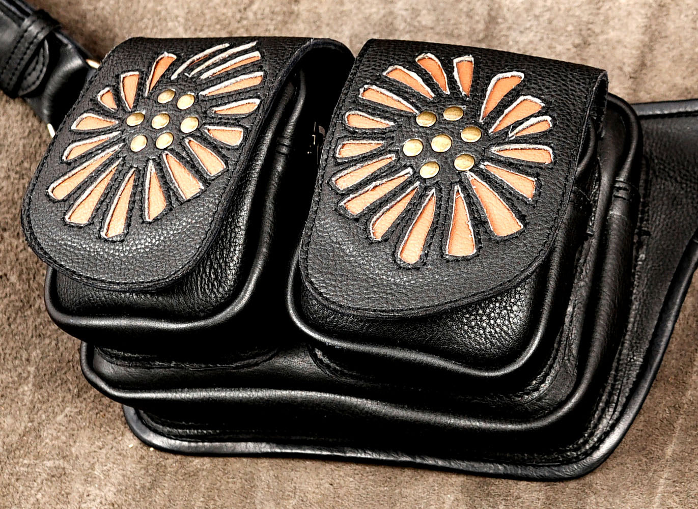 Handmade unisex leather belt bag with tan flower details and secure front pockets.