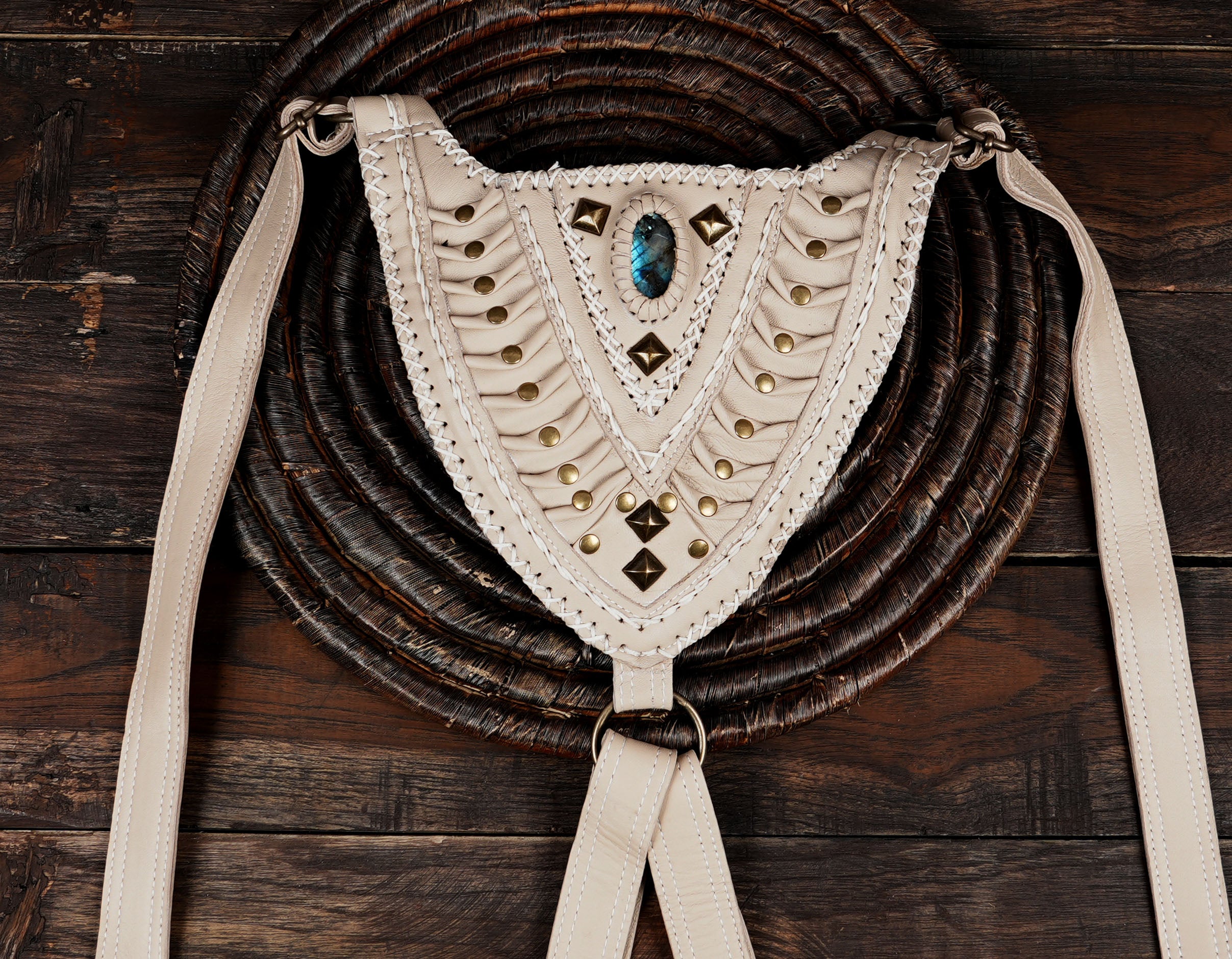 Cream-colored festival hip bag holster with detailed embroidery and metallic stud accents.