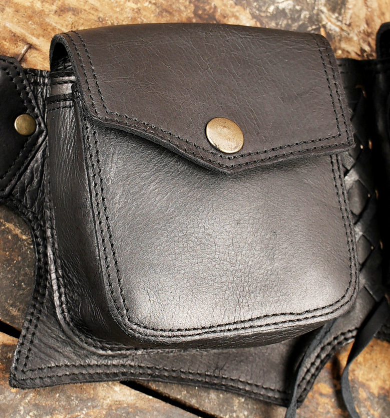 Heavy-duty black leather hip bag belt with zipper compartment, snap pouches, and dangling leather ties.