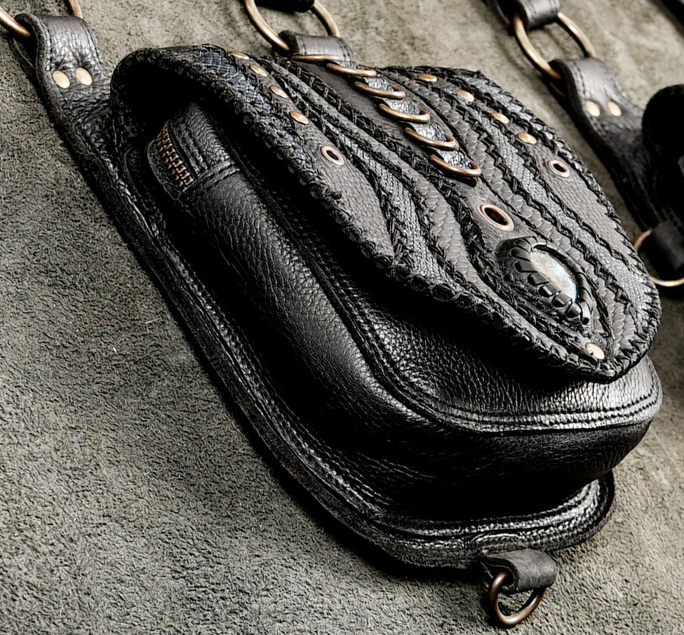 Genuine leather double holster chest bag featuring intricate tooling and twin front compartments for urban and rave outfits