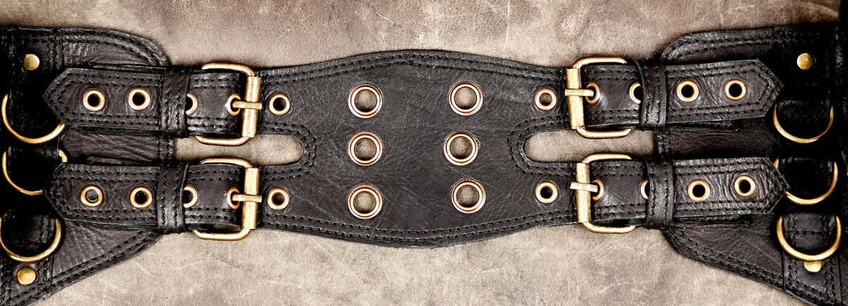 Adjustable leather waist bag with two smaller pouches and one large flap pocket.
