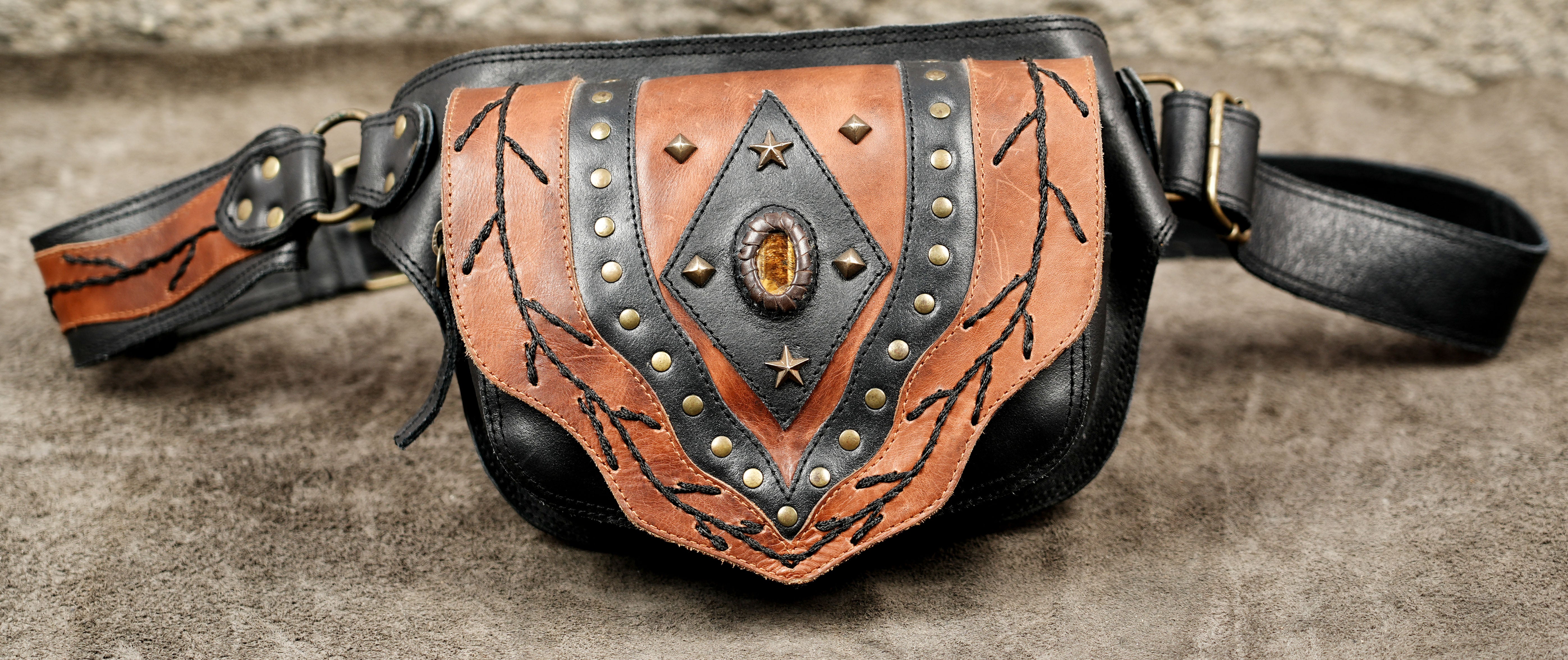Black leather waist pouch with tan tooled leather flap