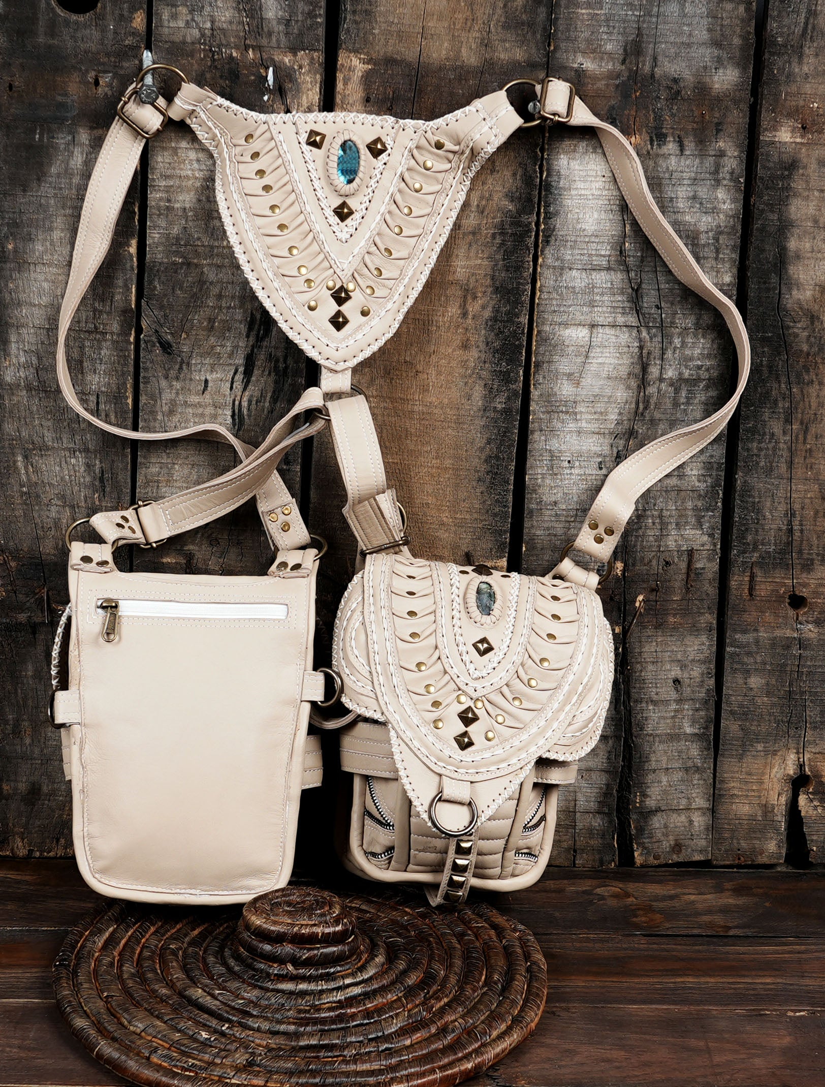Cream leather shoulder holster bag featuring boho tribal stitching and metal studs.