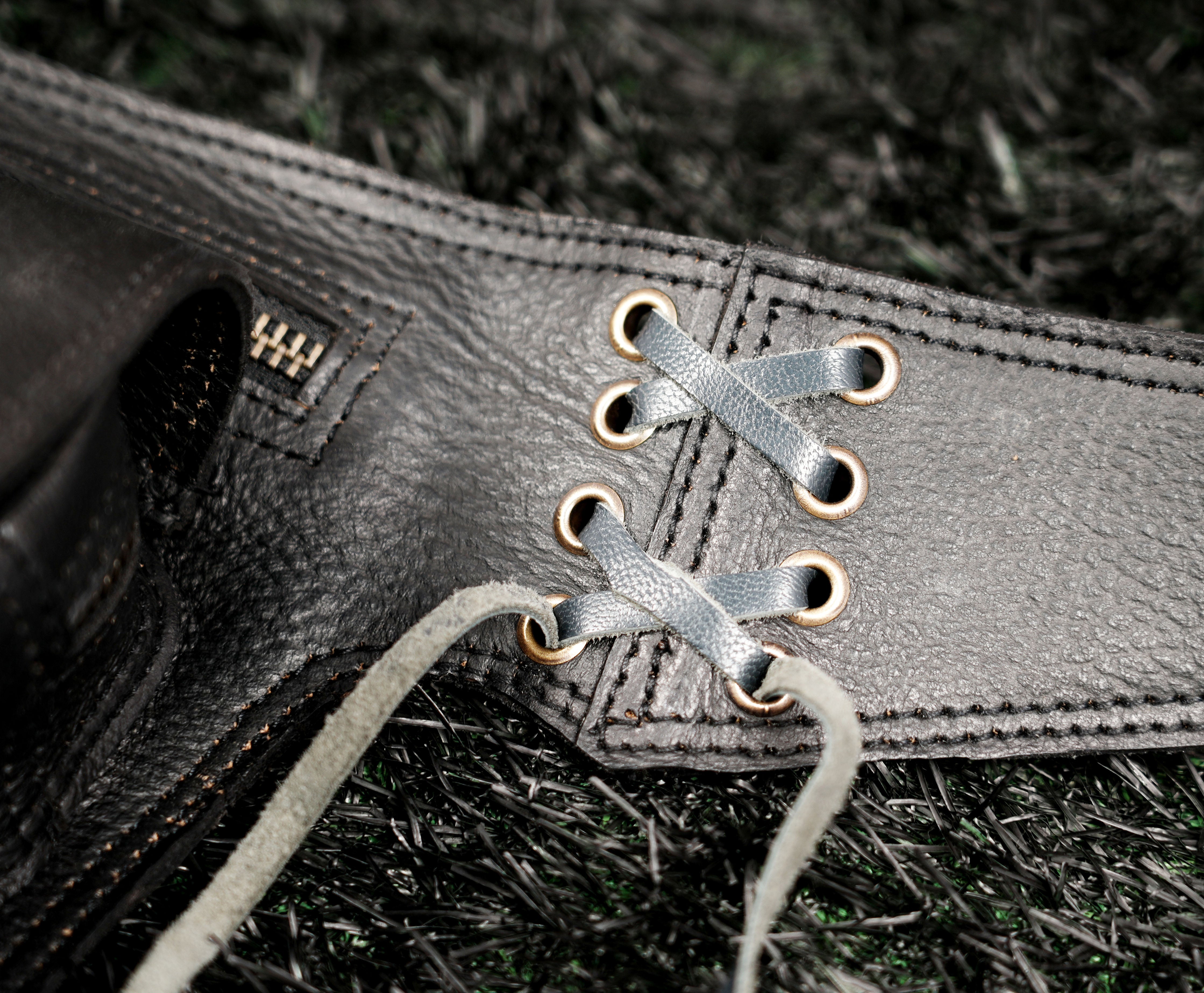 Black leather festival belt with labradorite gemstone, metal studs and practical storage pocket.