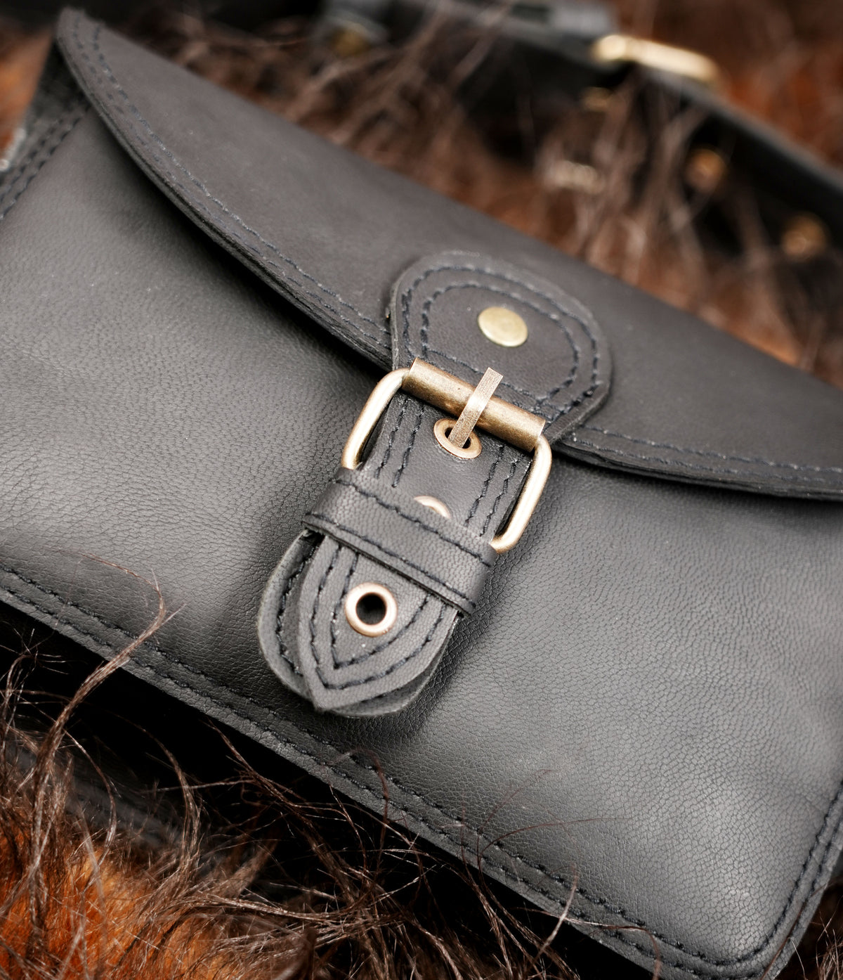 Small black leather bum bag with buckle detail and adjustable belt