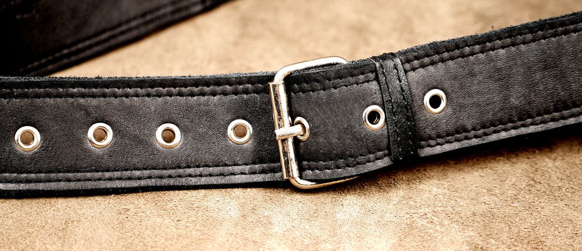 Braided leather stitching detail on a black hip holster bag