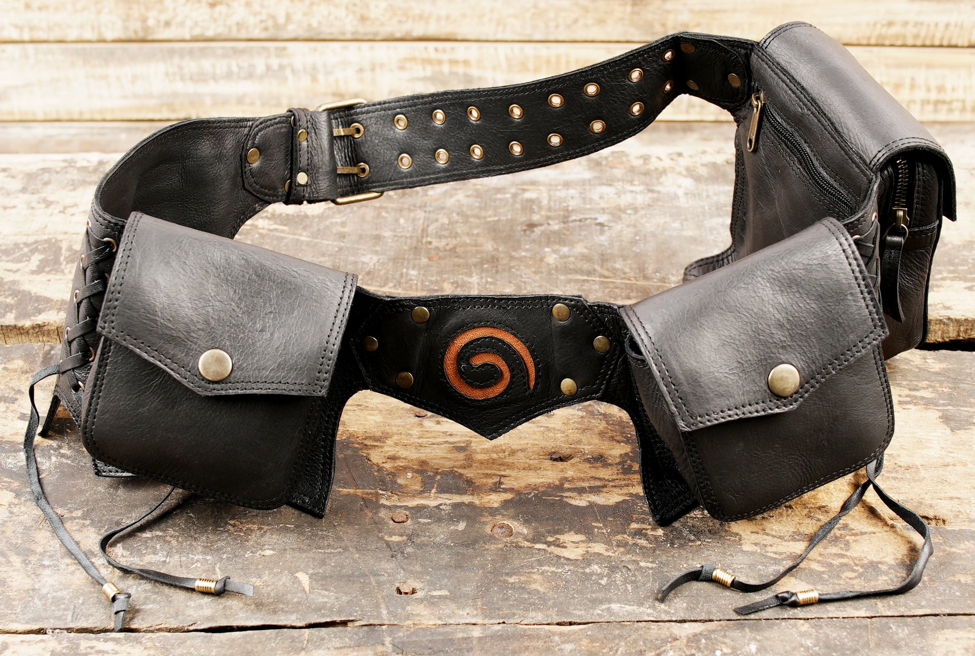 Burning Man style black leather hip pack belt with pockets and lace-up festival utility design.