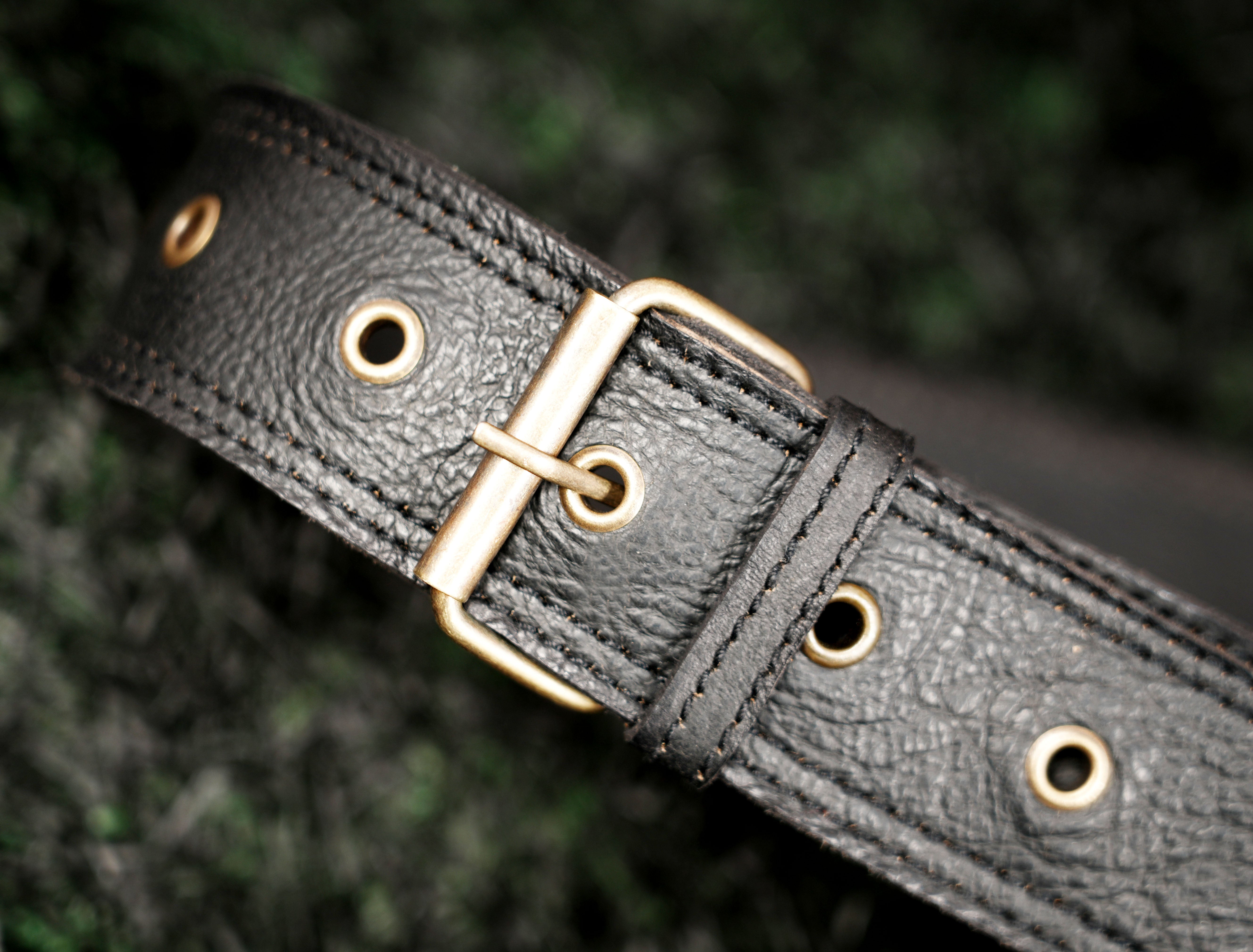 Boho leather waist pouch featuring a colorful labradorite stone and antique brass stud detailing.