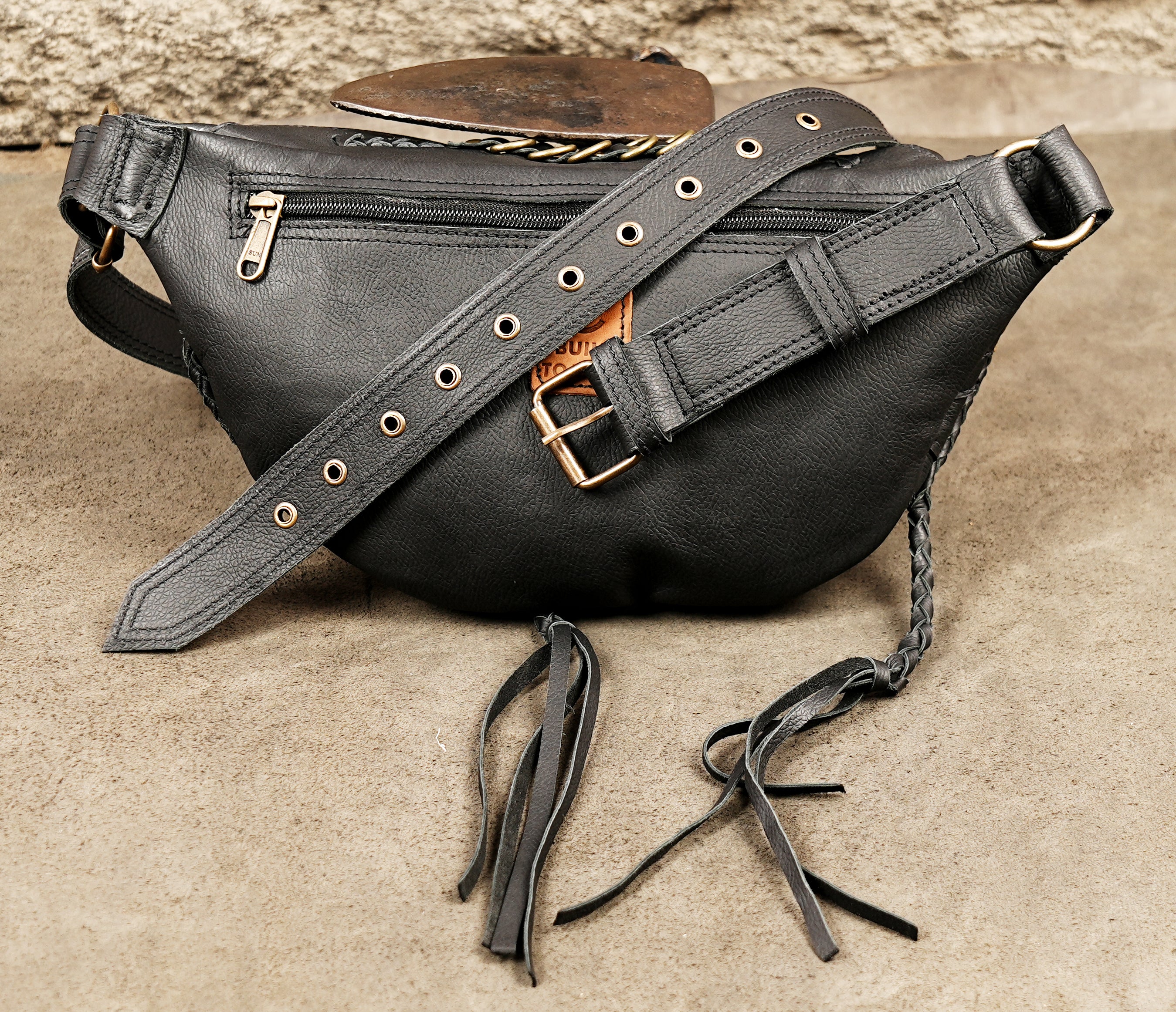 Unisex black leather hip bag holster with brass-tone hardware and adjustable waist strap.