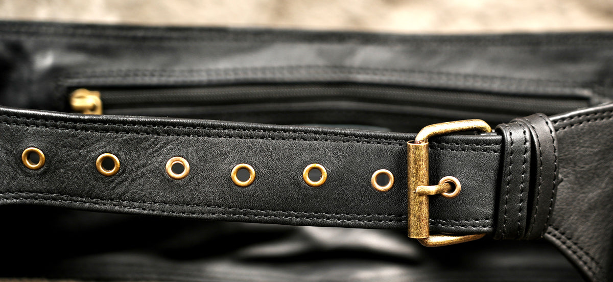 Multi-compartment black leather belt bag with brass buckles