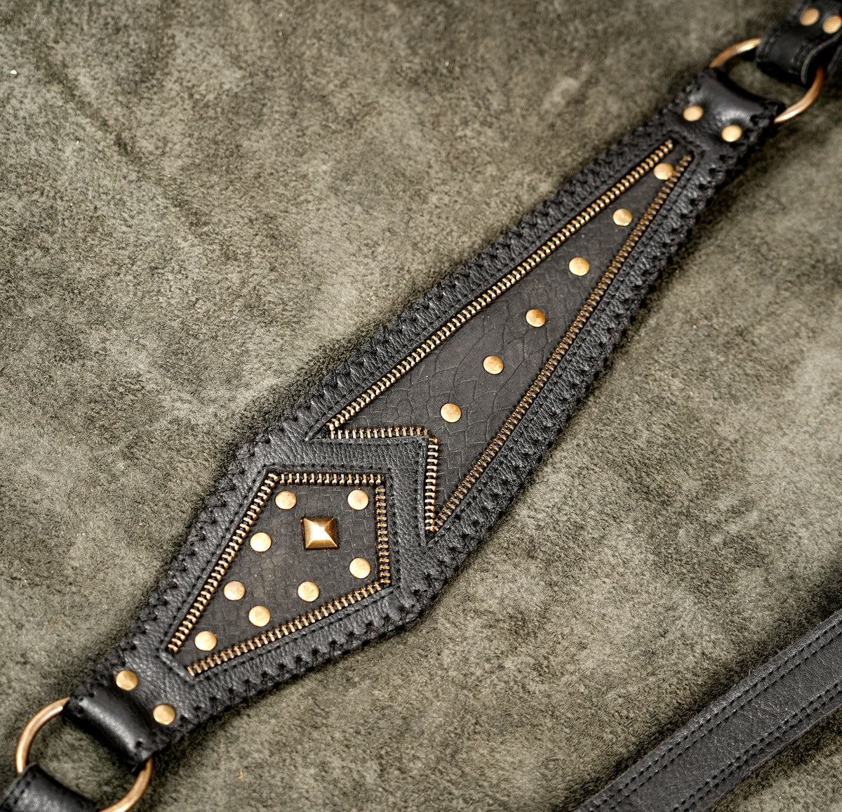 Gothic and tribal style leather body harness bag featuring dual front utility bags and brass-toned studs