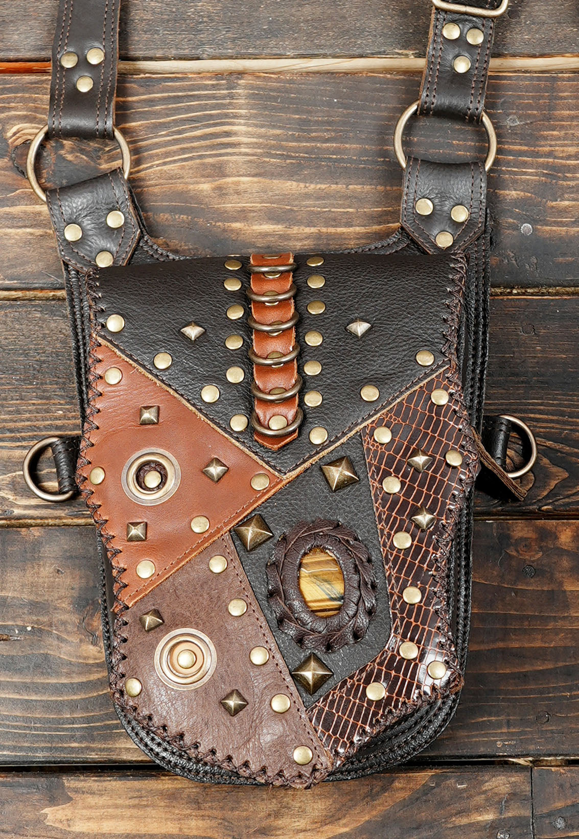 Handmade leather hip holster with brass studs and textured panels