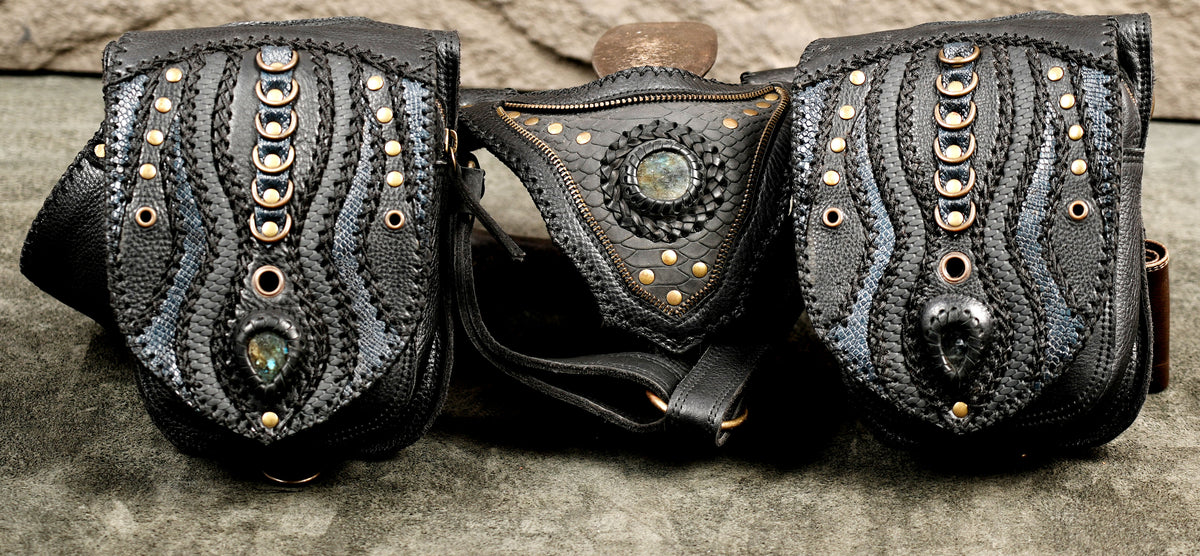 Statement black leather dual holster bag designed with symmetrical side pockets and intricate carved detailing