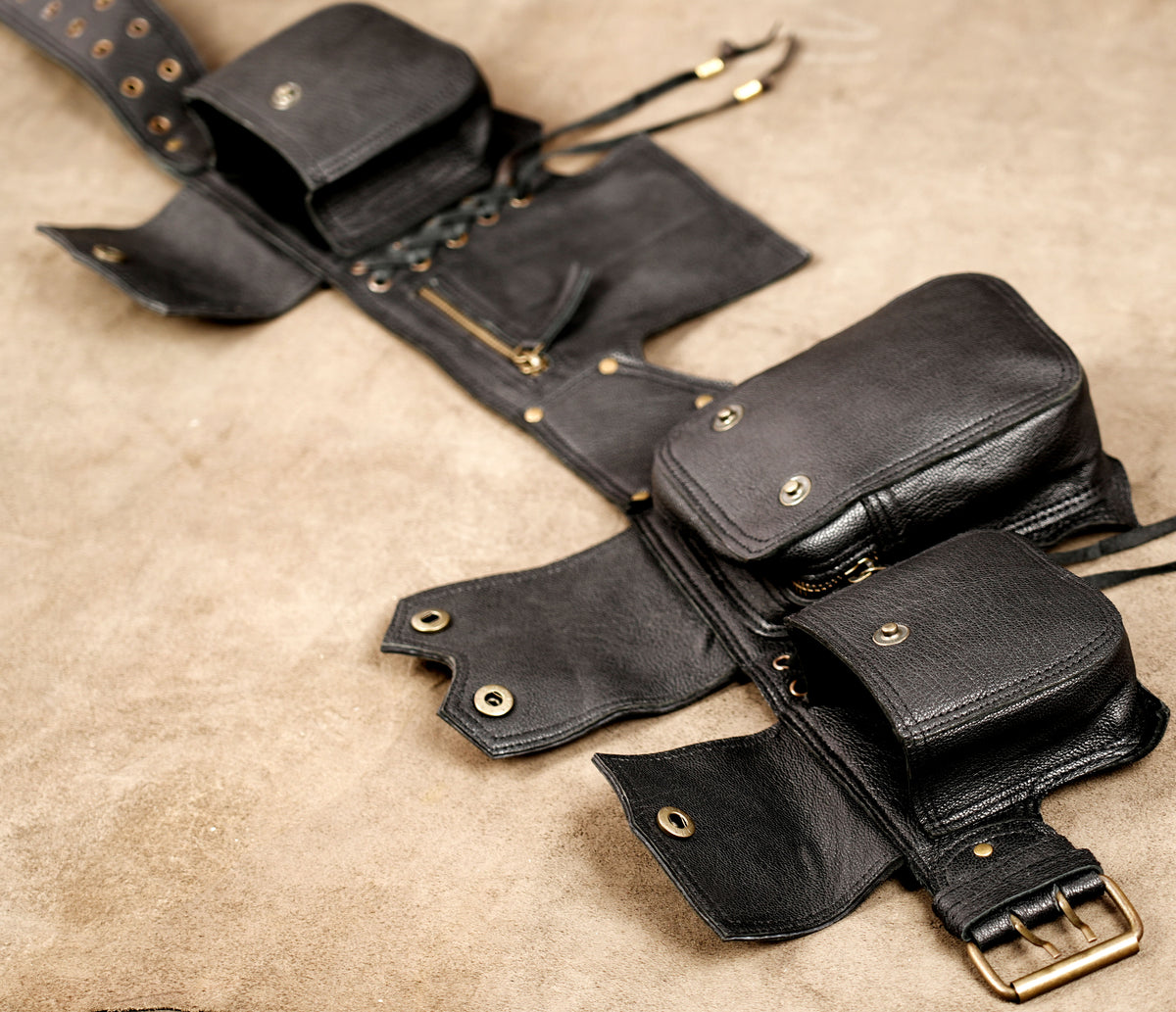 Adjustable leather belt with brass buckle, full flat lay