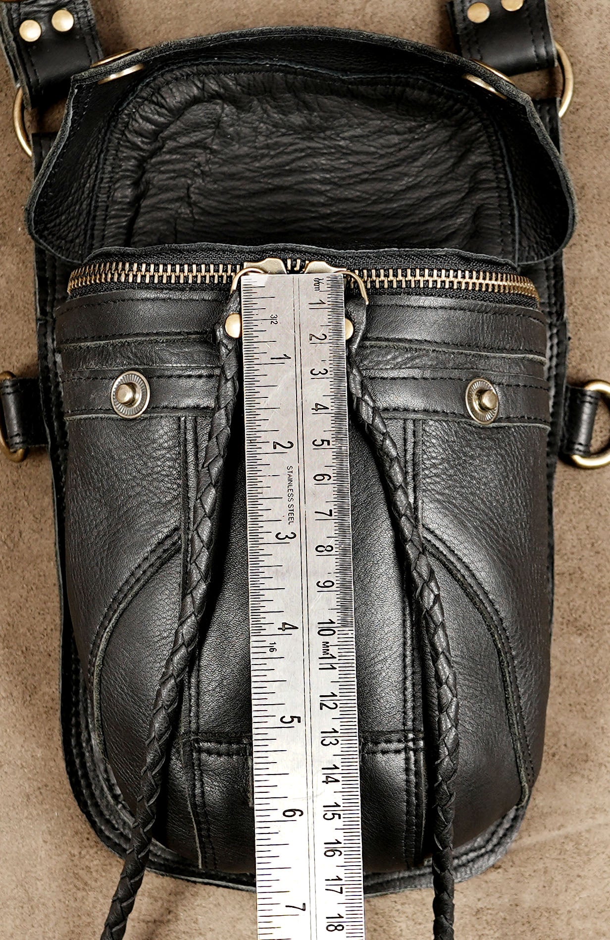 Adjustable leather body holster with brass clips and pouches