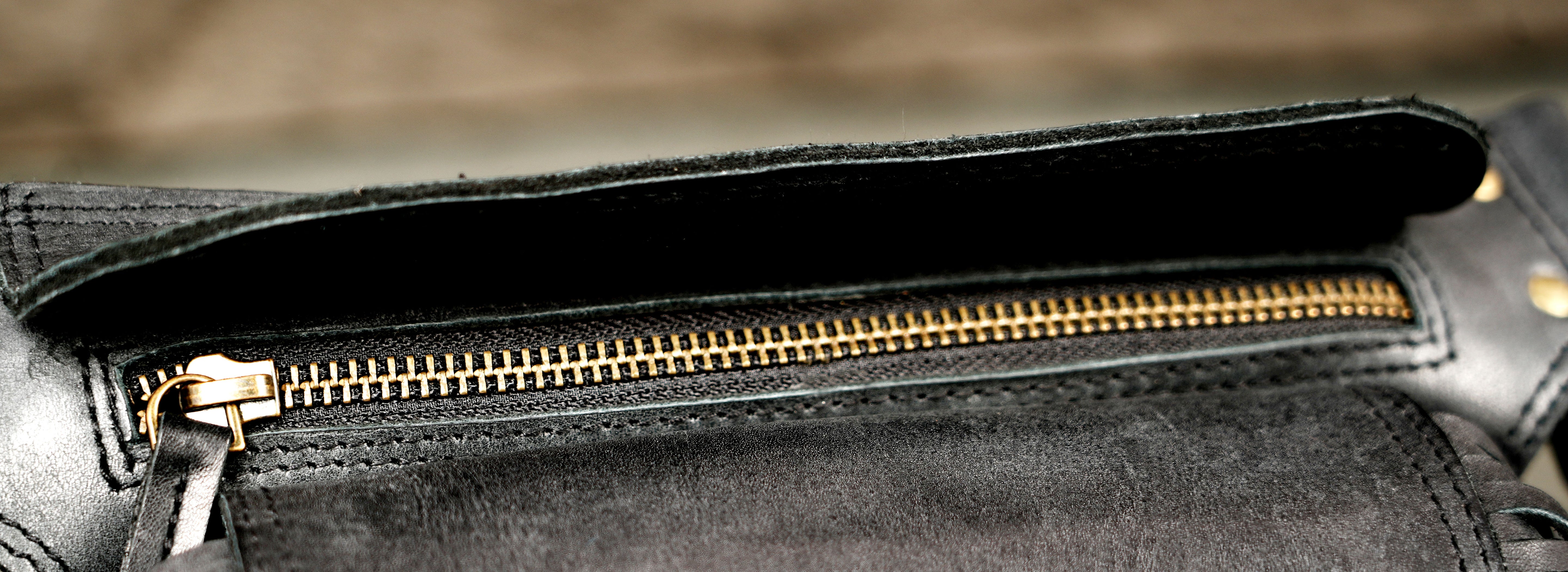 Adjustable leather hip bag with braided medallion and fringe
