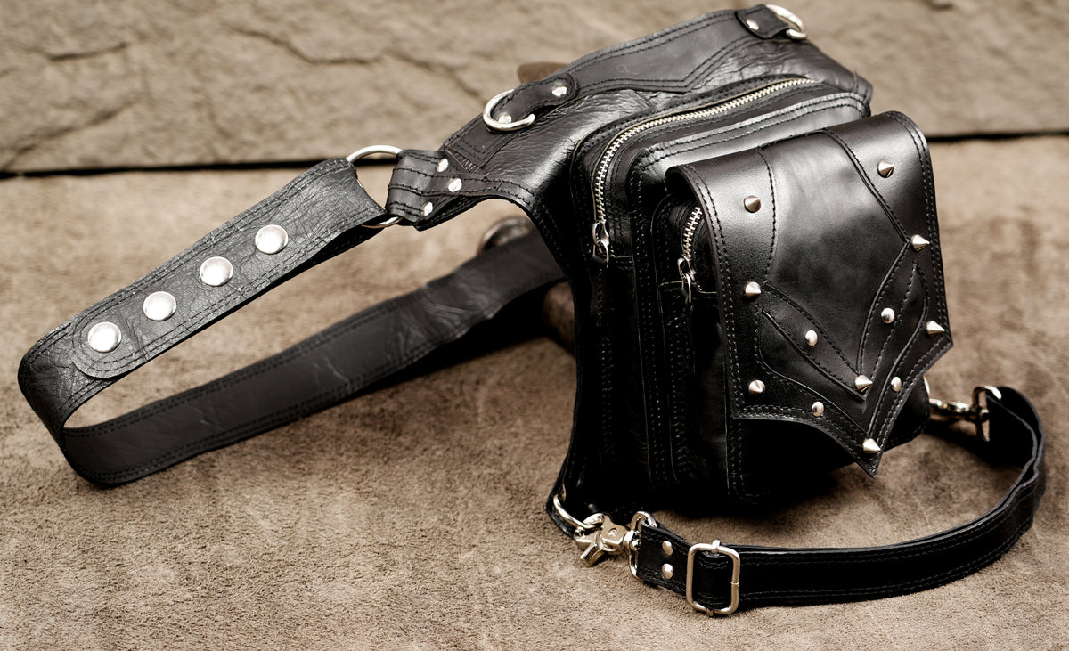 Adjustable leather leg pouch with clip strap detail