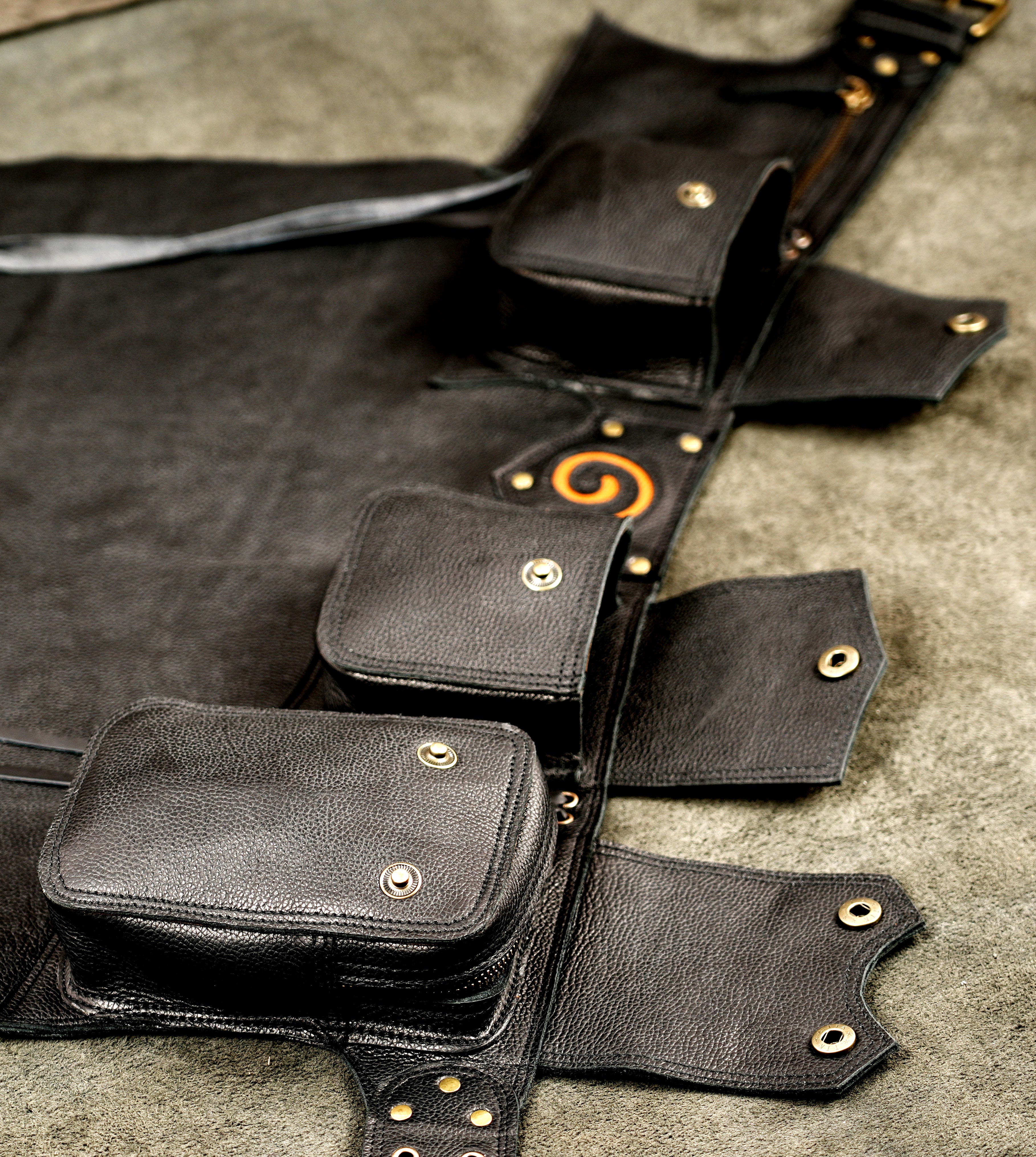 Adjustable leather utility skirt with grommet hem trim