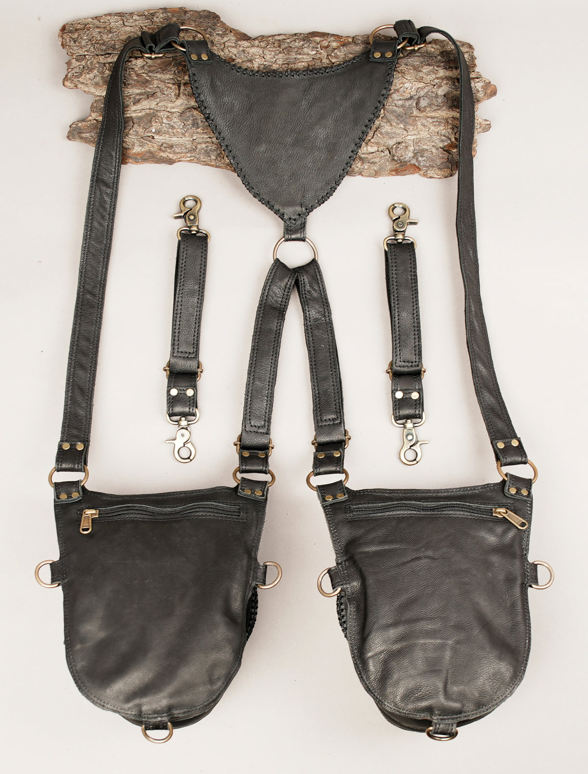 Black leather suspender-style bag set with two large pouches and a central harness strap.