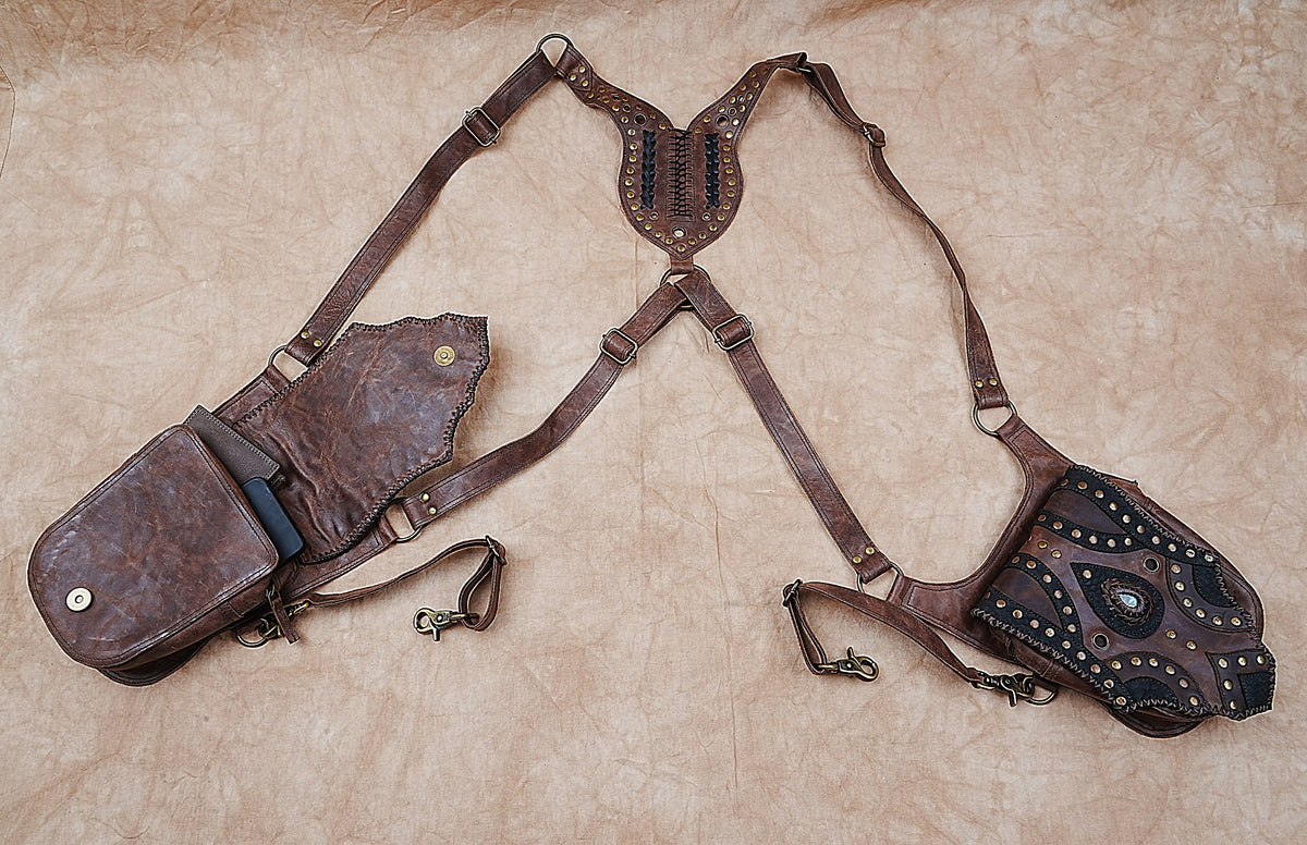 Brown leather utility bag with two flap pockets and decorative gemstone accents
