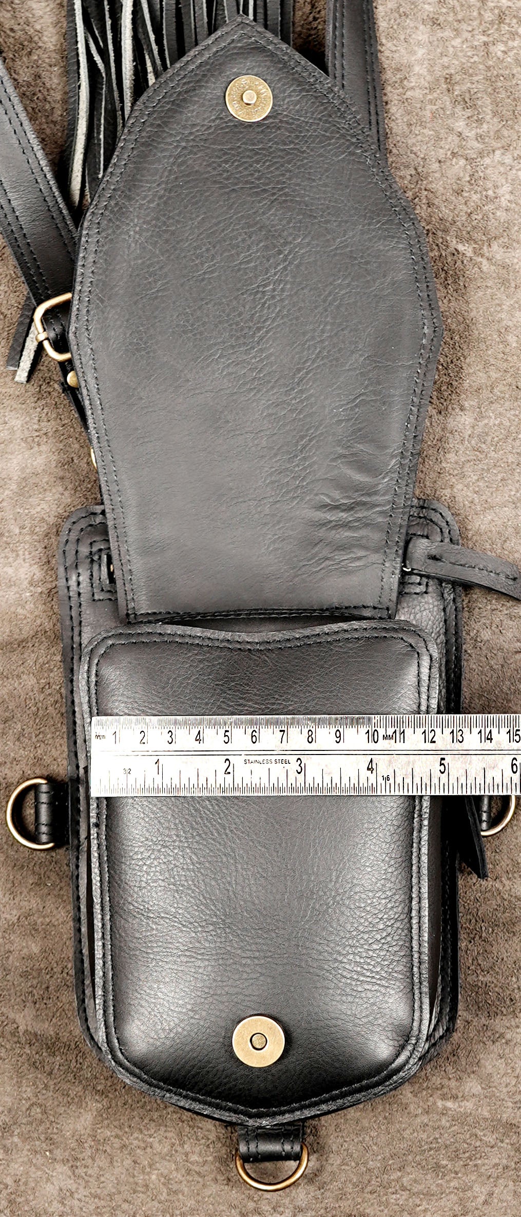 Burning Man leather festival holster bag with long back tassels and dual front storage pockets.