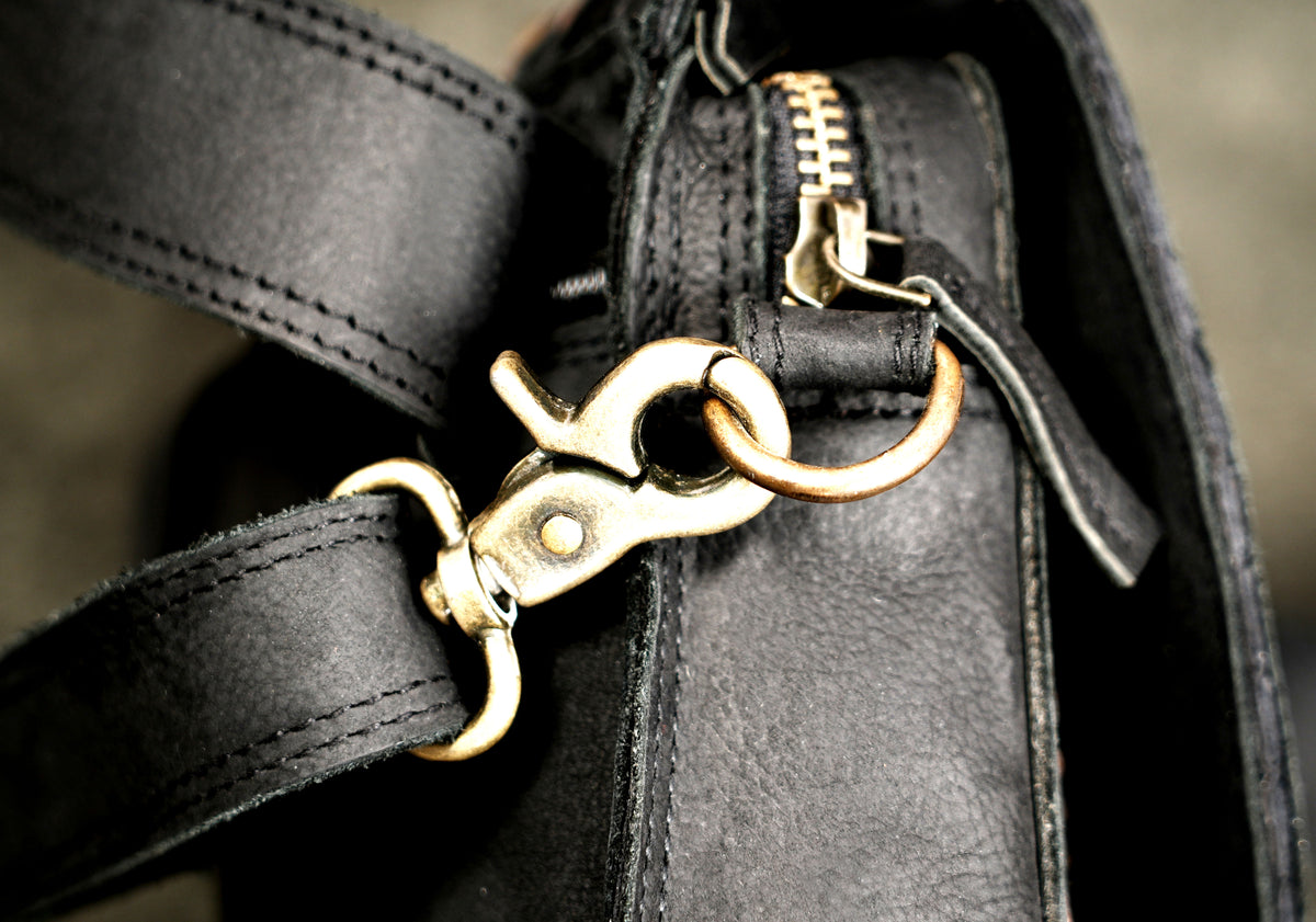 Black leather convertible waist bag with detachable strap and swivel hooks