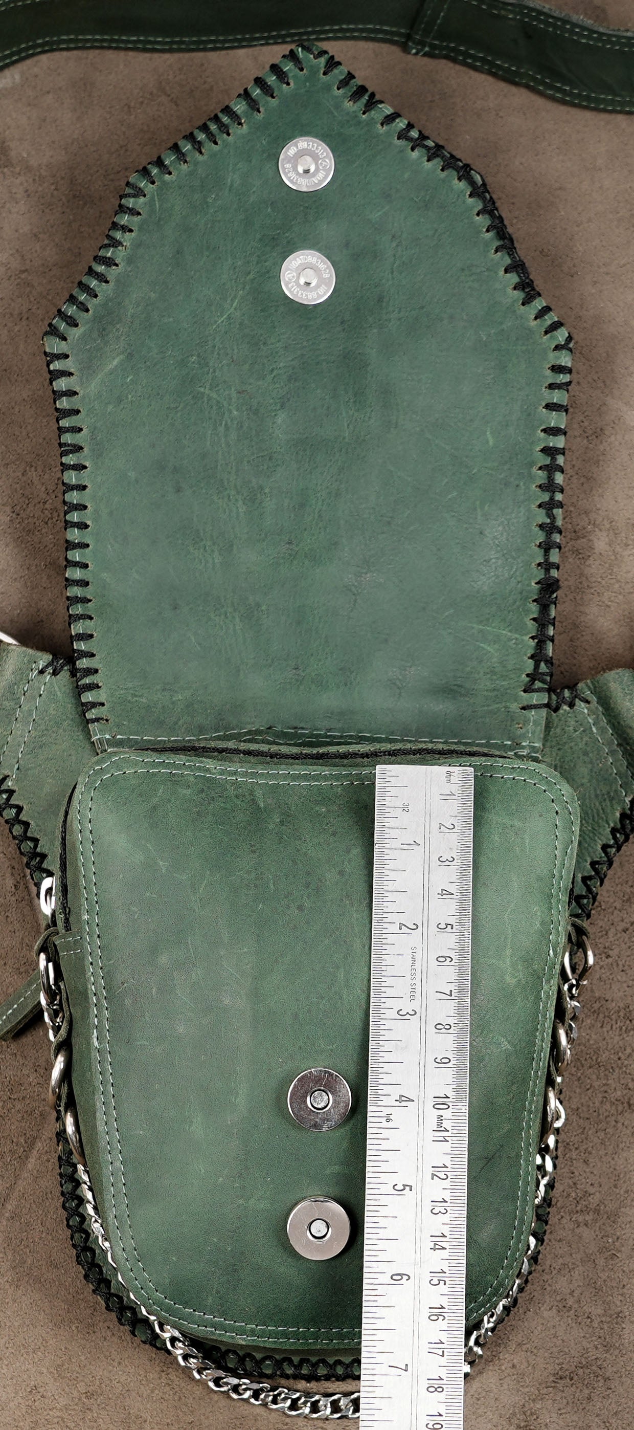Artisan-made green leather waist bag with chain detail