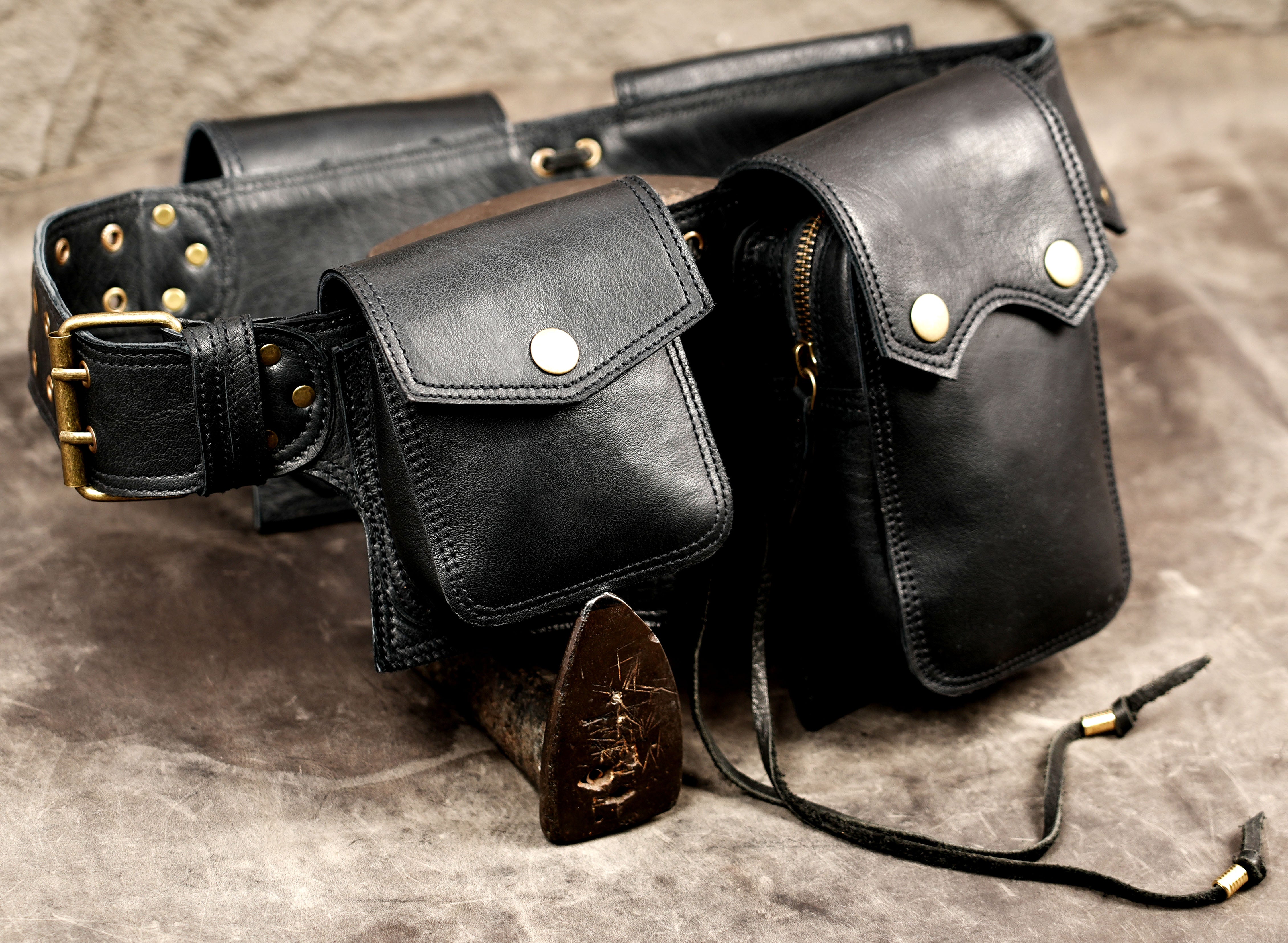 Artisan black leather waist bag with buckle closure
