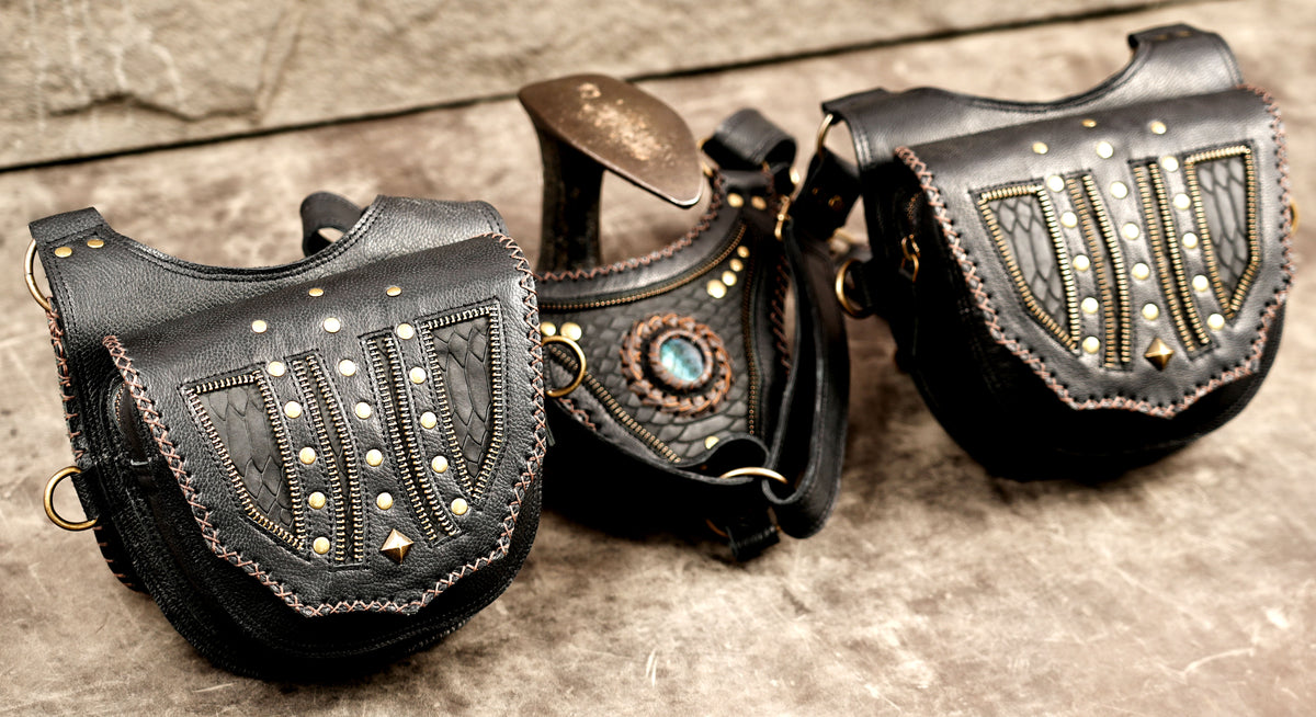 Gothic black leather harness bag set with metal studs and braided edging

