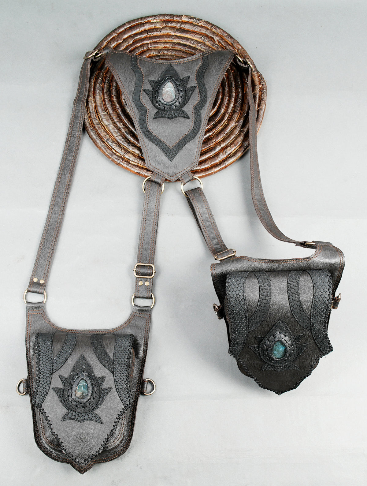 Handmade double hip bag with adjustable leather straps and ornate geometric pouch designs.