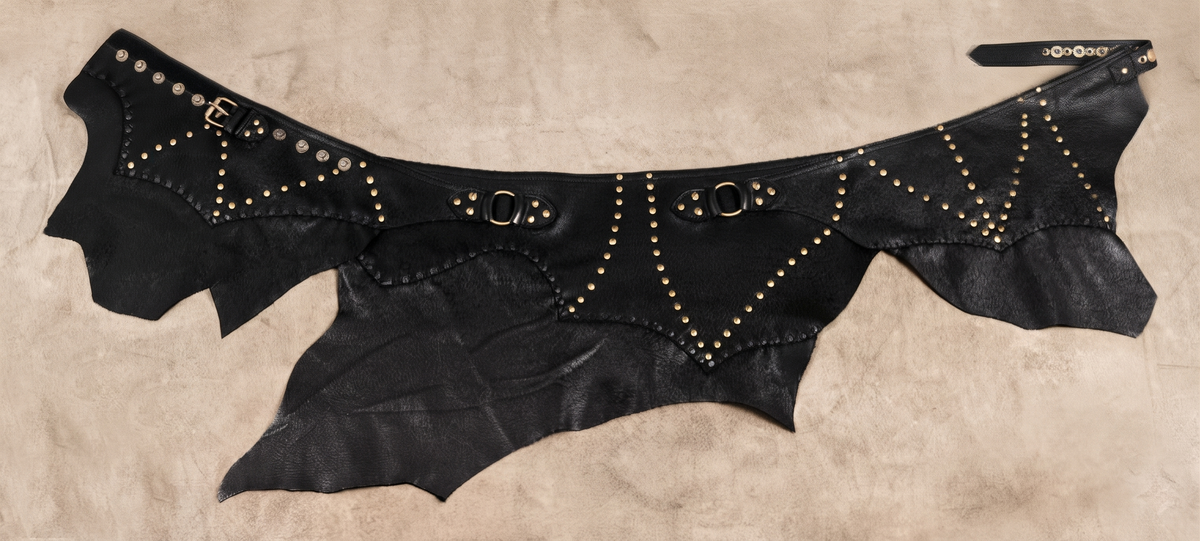 Dark brown leather rave fashion skirt with studded patterns and handcrafted trim
