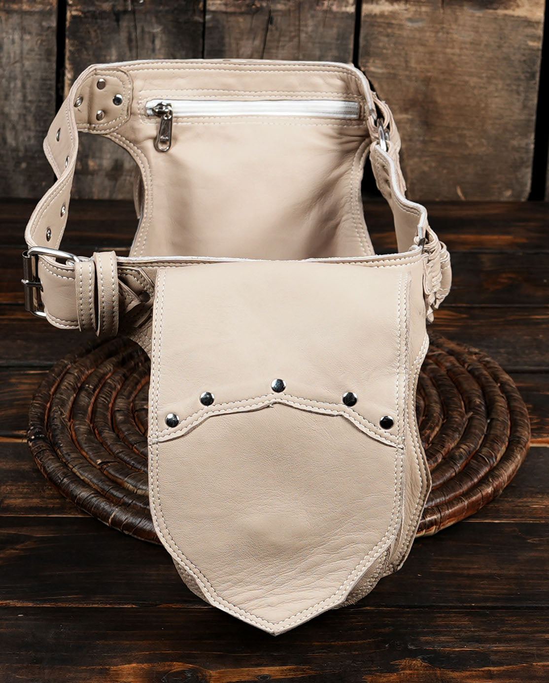 Beige leather pouch belt, wicker background product shot