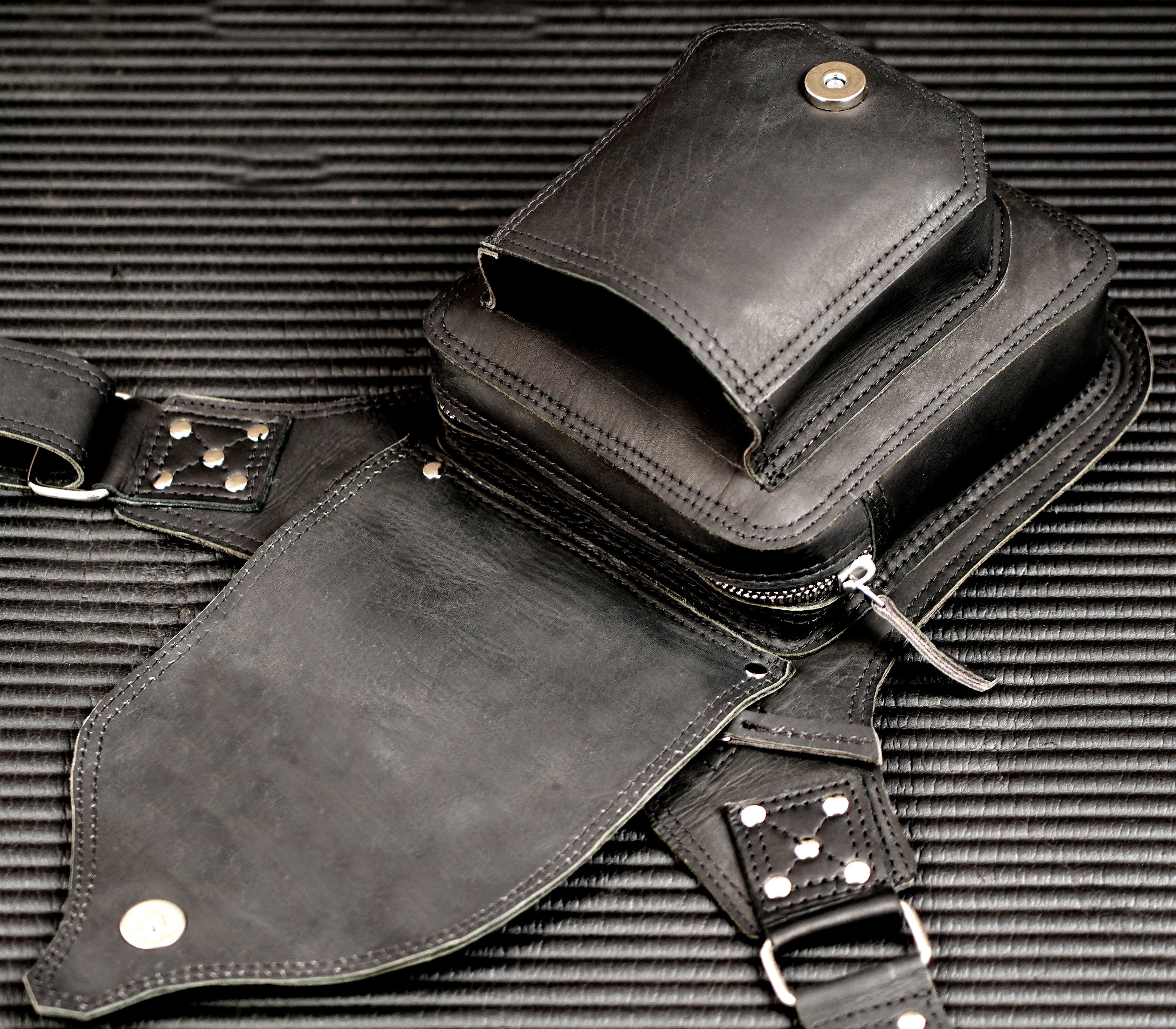 Biker-style black leather belt bag with antique brass hardware