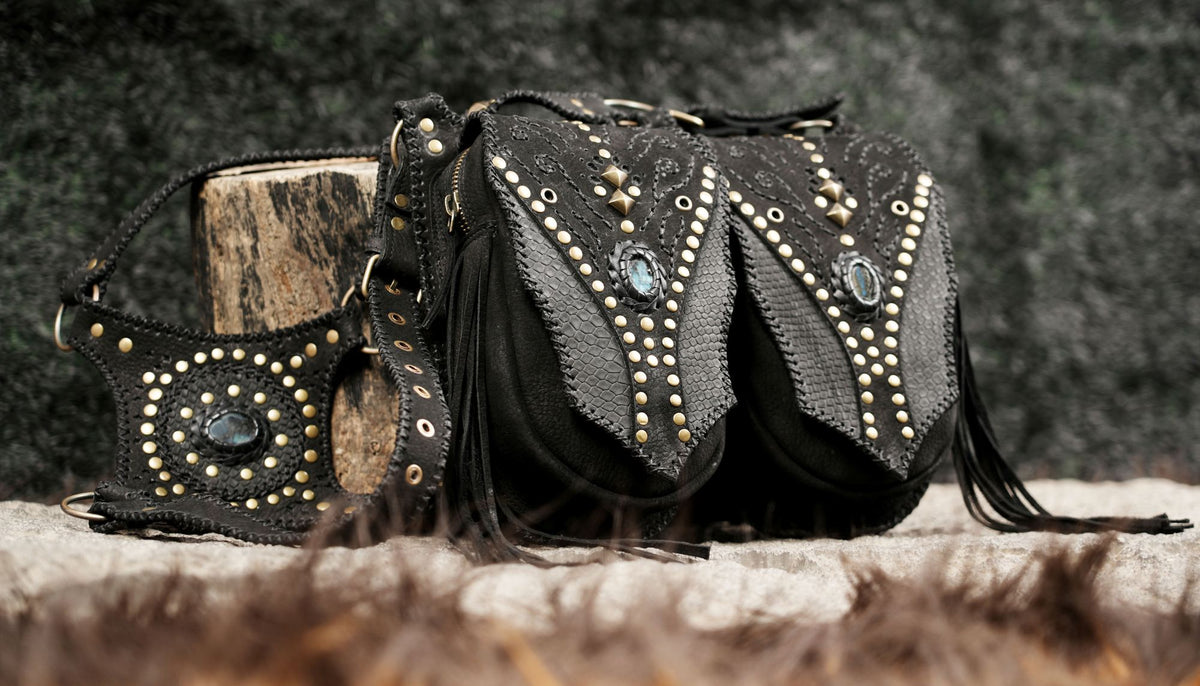 Black leather double leg pouch harness with decorative gemstones and metal stud detailing.

