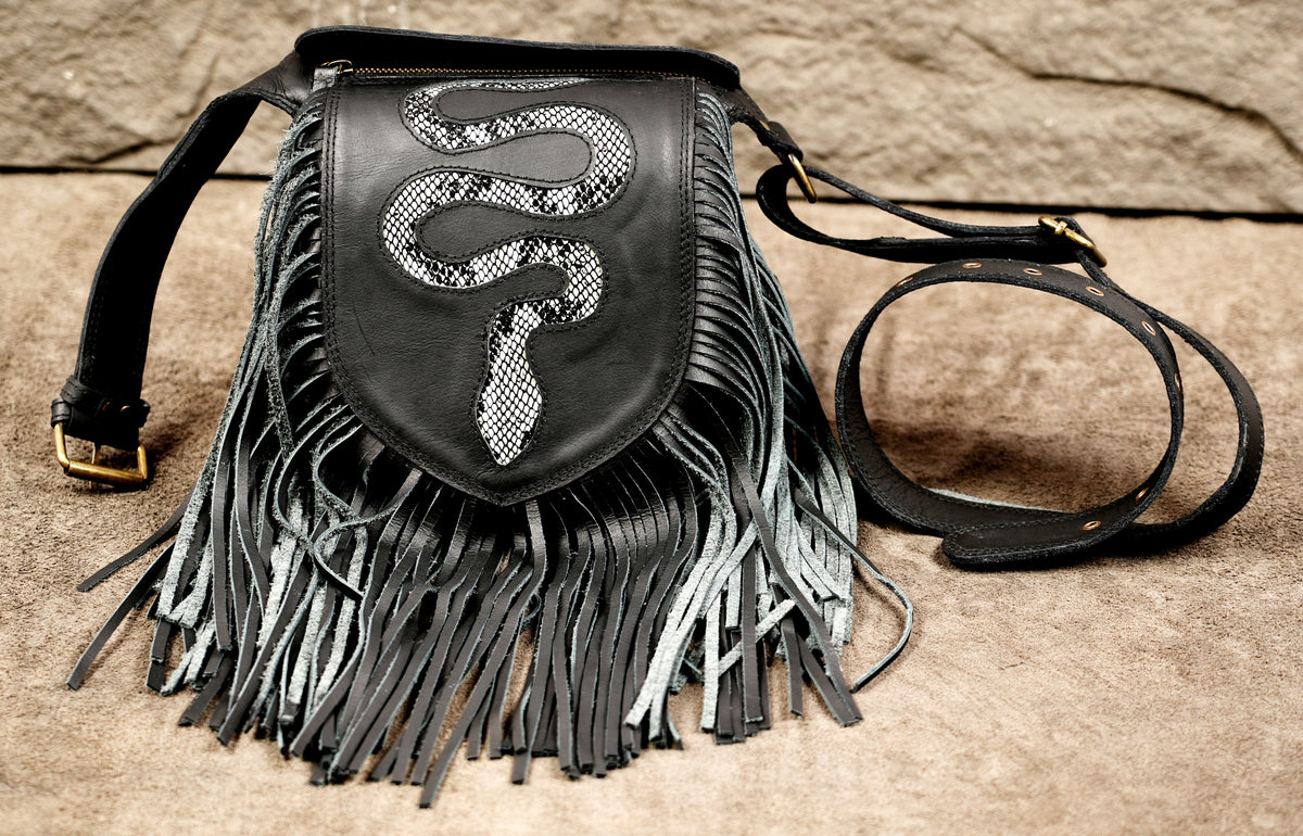 Black leather fringe crossbody bag with a snakeskin-patterned snake applique on the front.