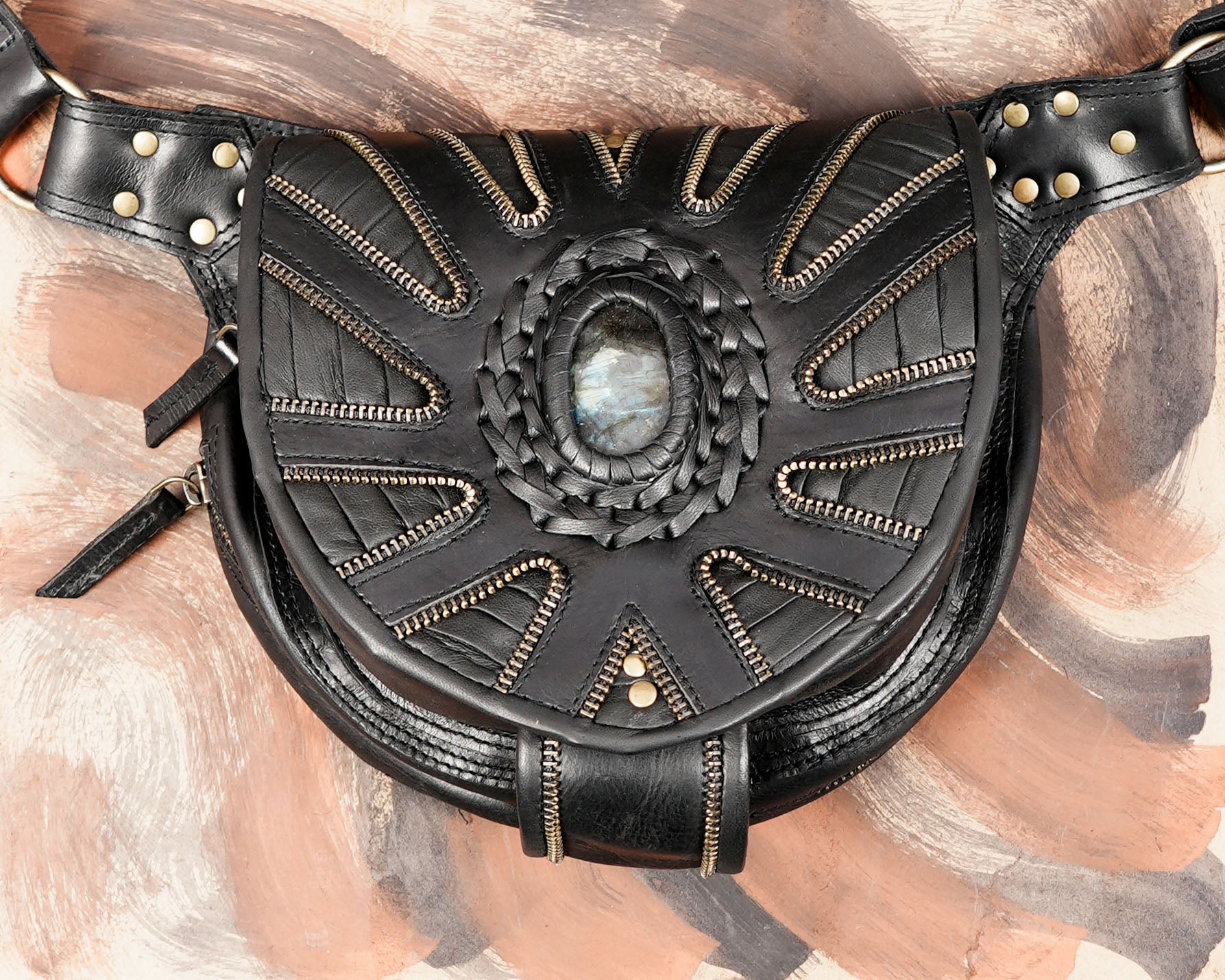Black festival belt bag with decorative sunburst leather design