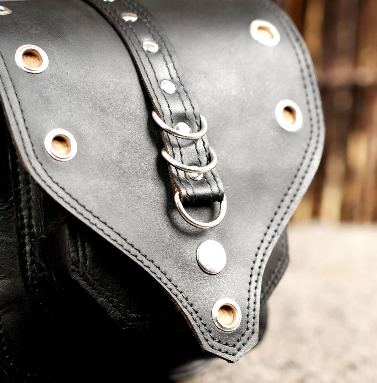 Black leather belt bag with V stitch pattern, close up