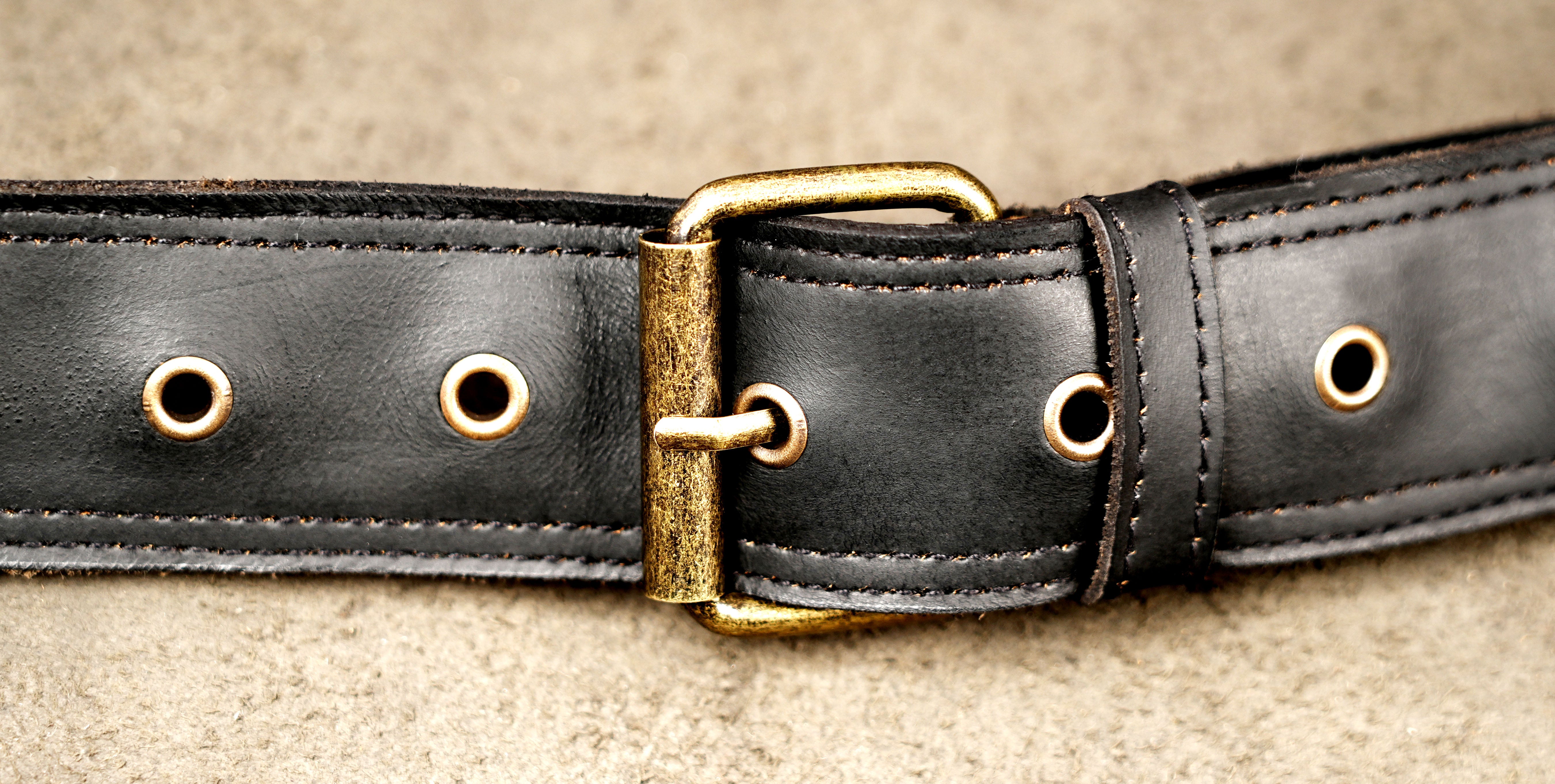 Black leather belt bag with double pocket design and zipper