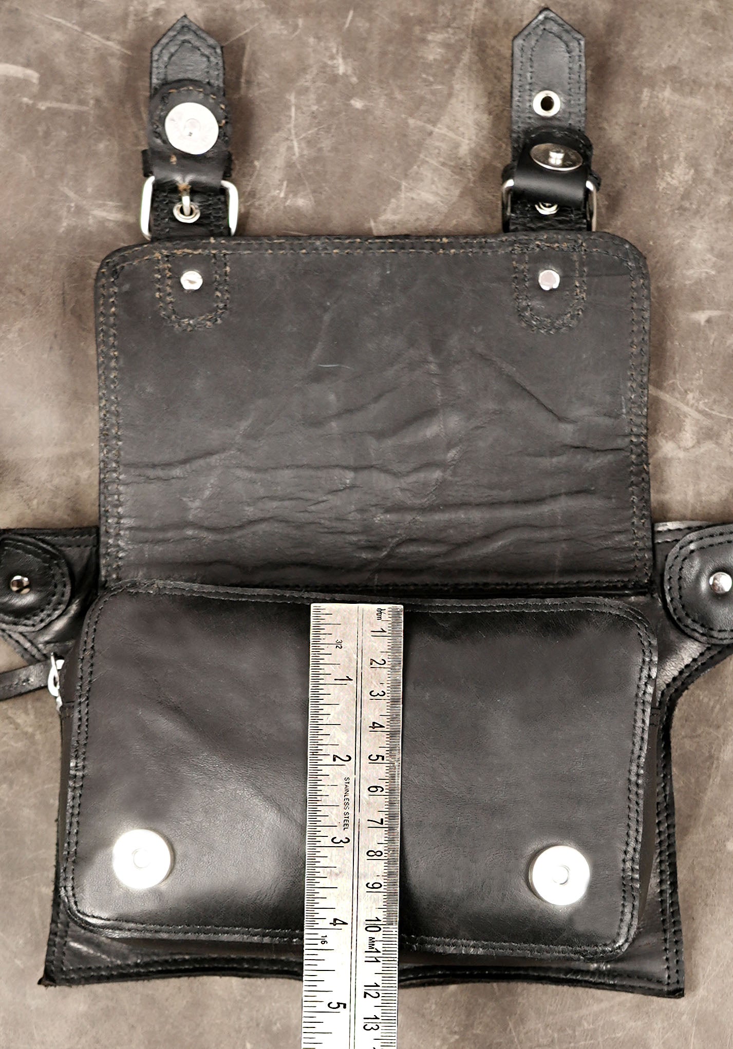 Black leather crossbody pouch with double buckle detail