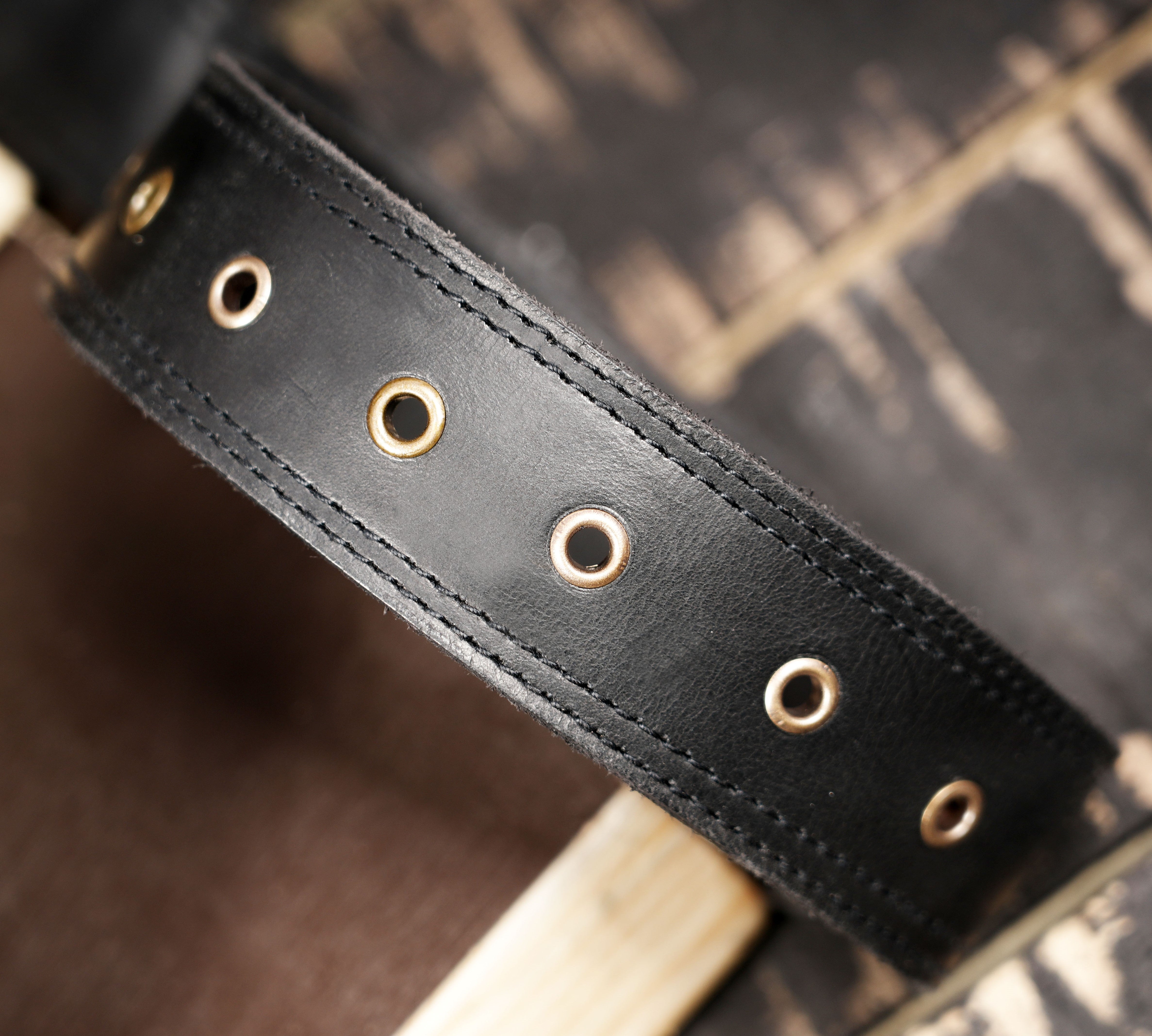Black leather fanny pack with sunray stitching and braided stone