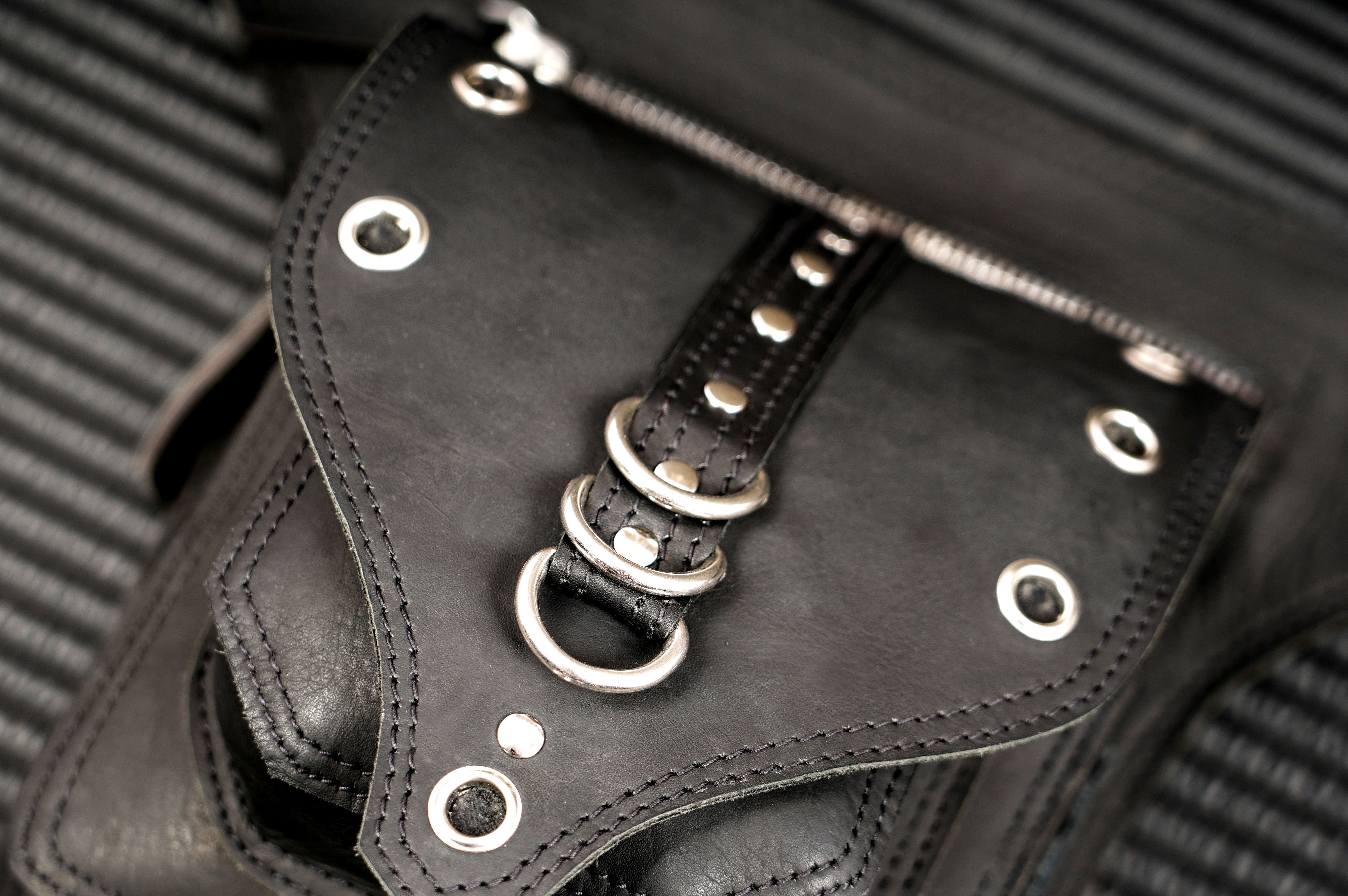 Black leather festival belt bag with decorative brass rings
