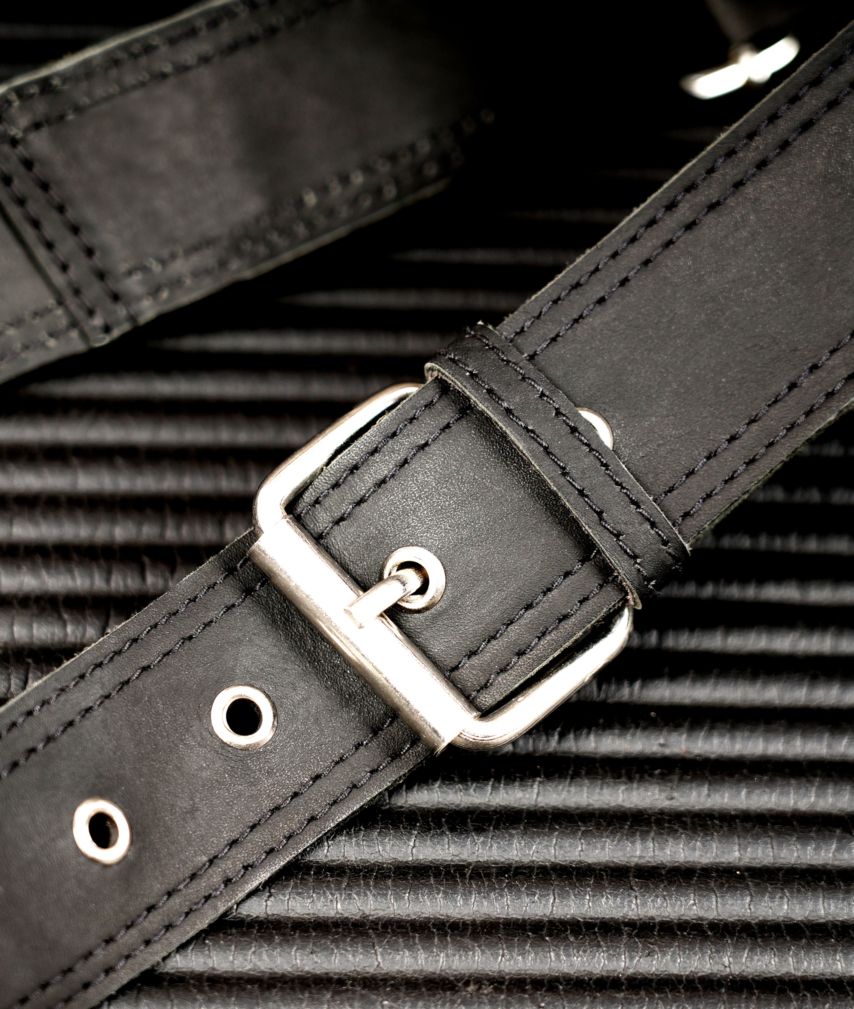 Black leather hip bag with antique brass zipper and secure pocket