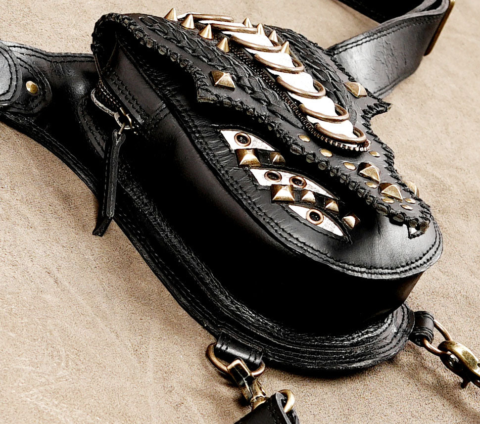 Black leather leg bag with decorative shell detailing