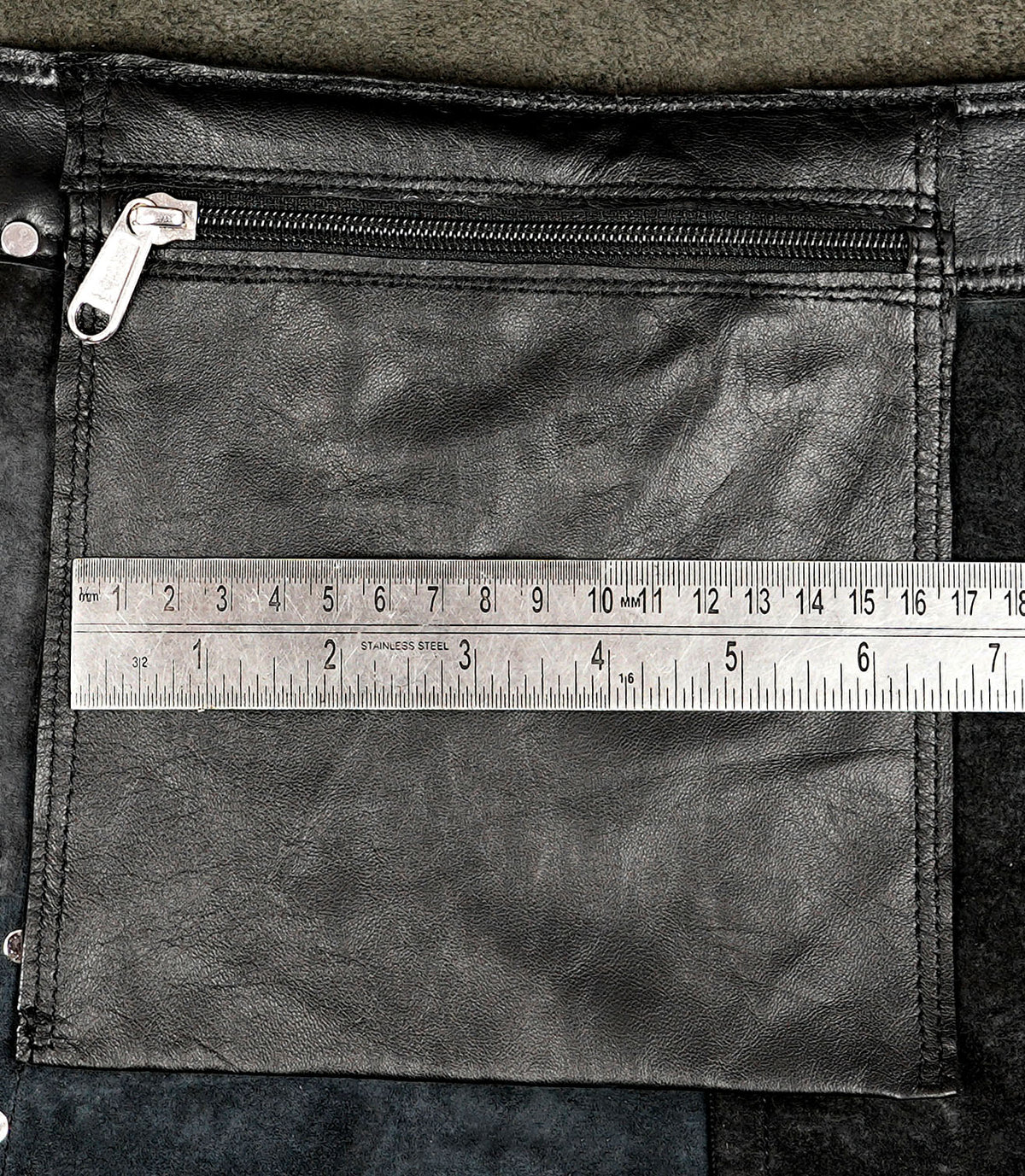 Black leather mini skirt with adjustable eyelet strap