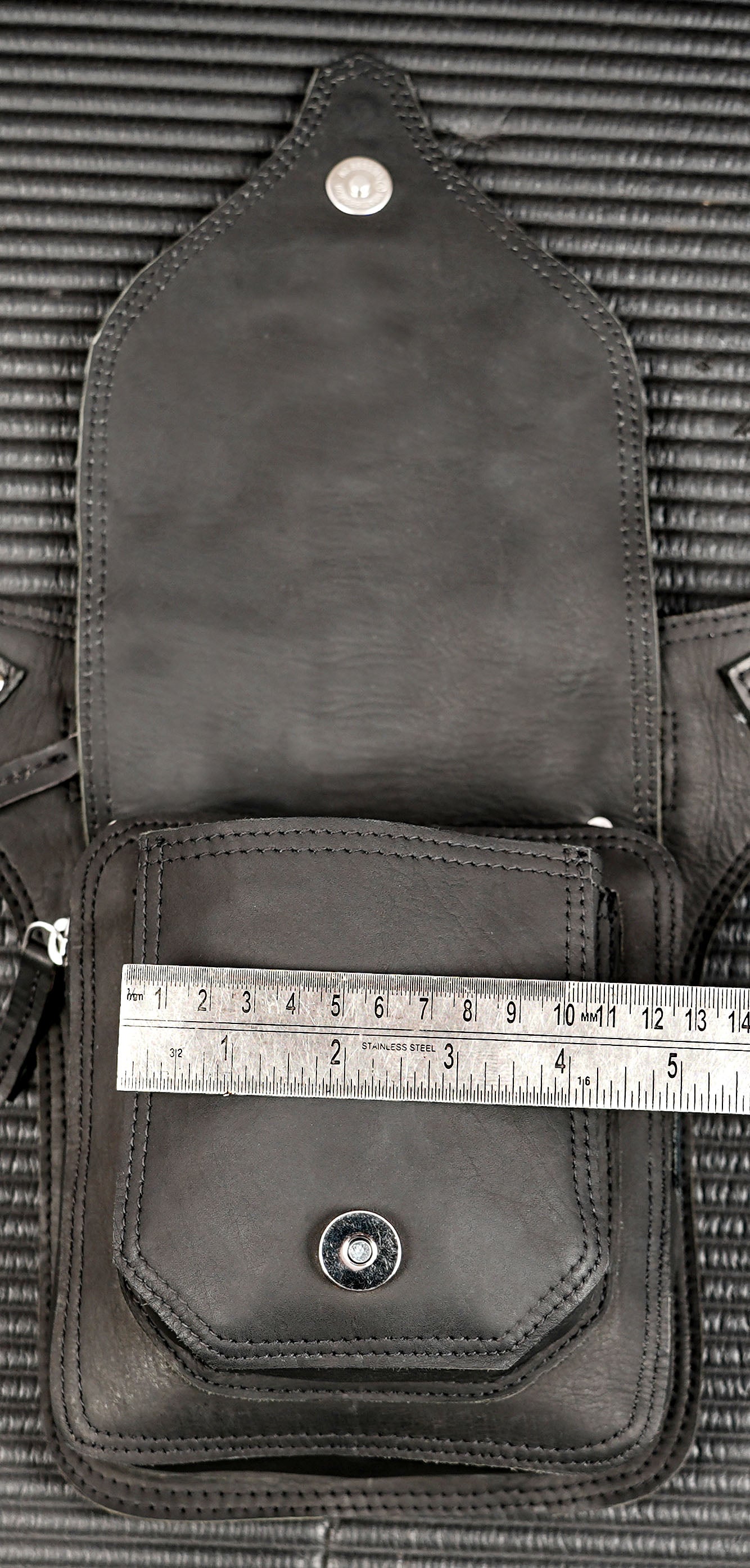 Black leather travel pouch with flap and zipper compartments